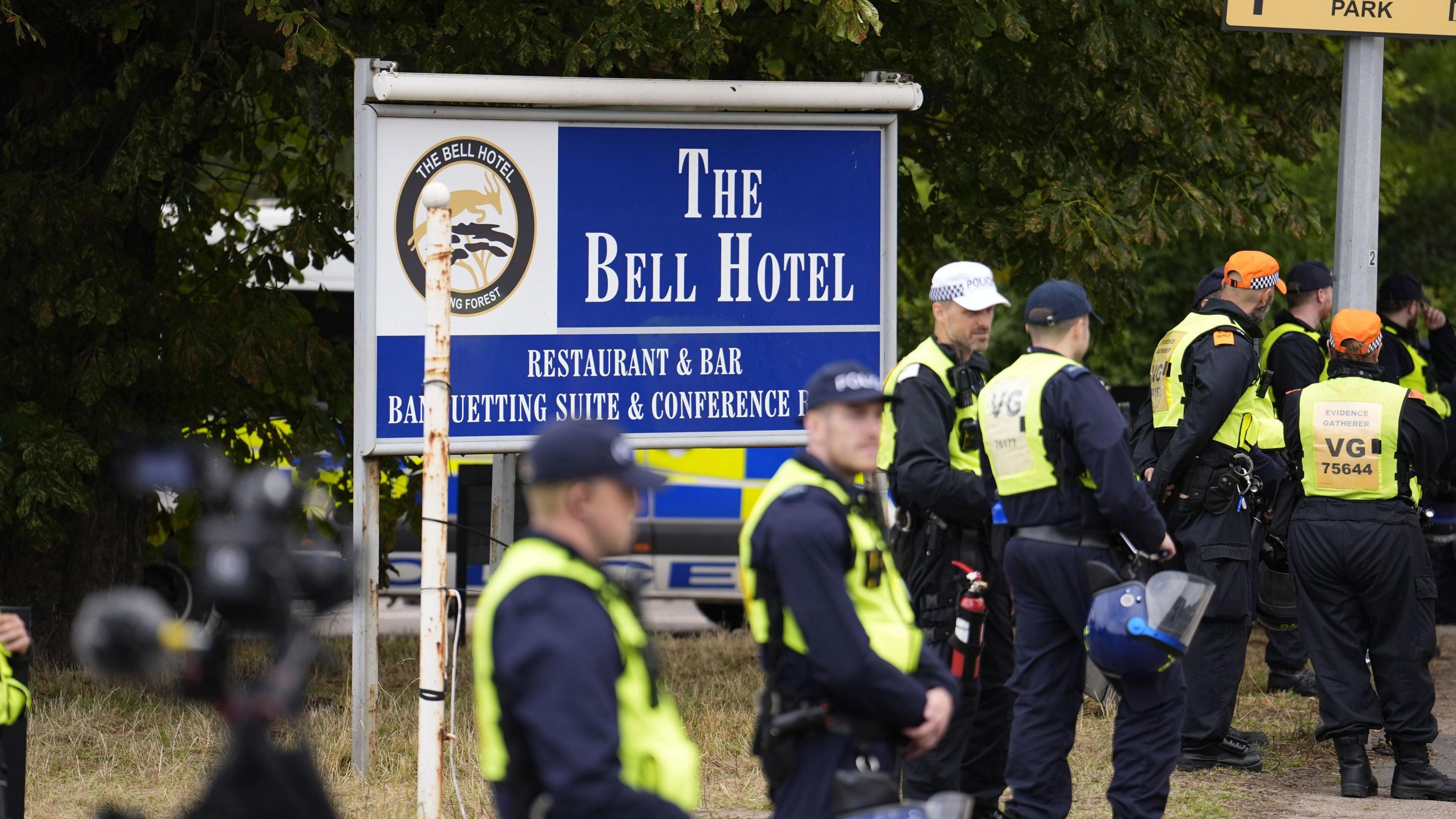 Police officers ahead of a demonstration outside the former Bell Hotel in Epping