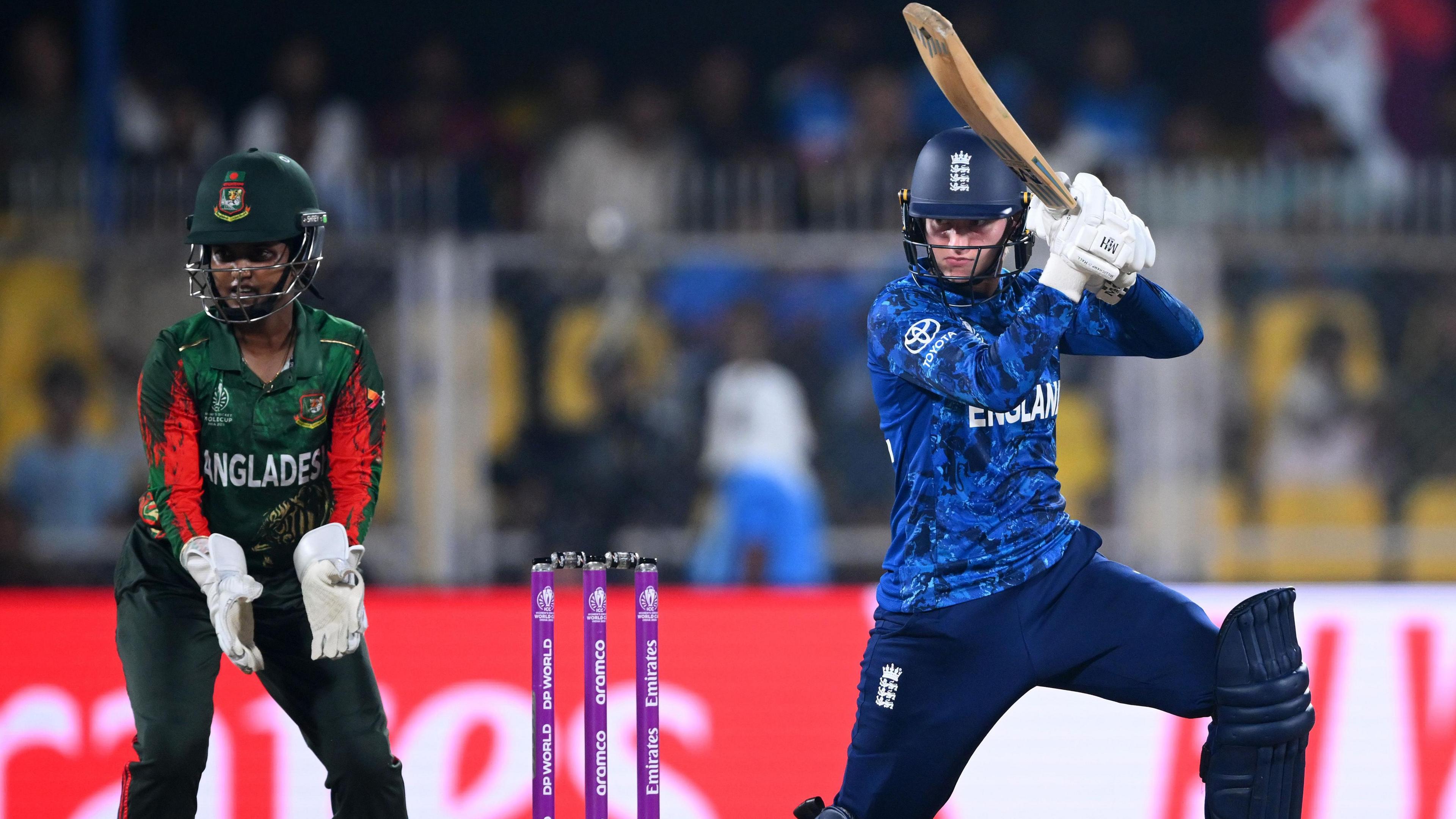 England batter Charlie Dean hits out, watched by Bangladesh wicketkeeper Nigar Sultana Joty, at the 2025 World Cup