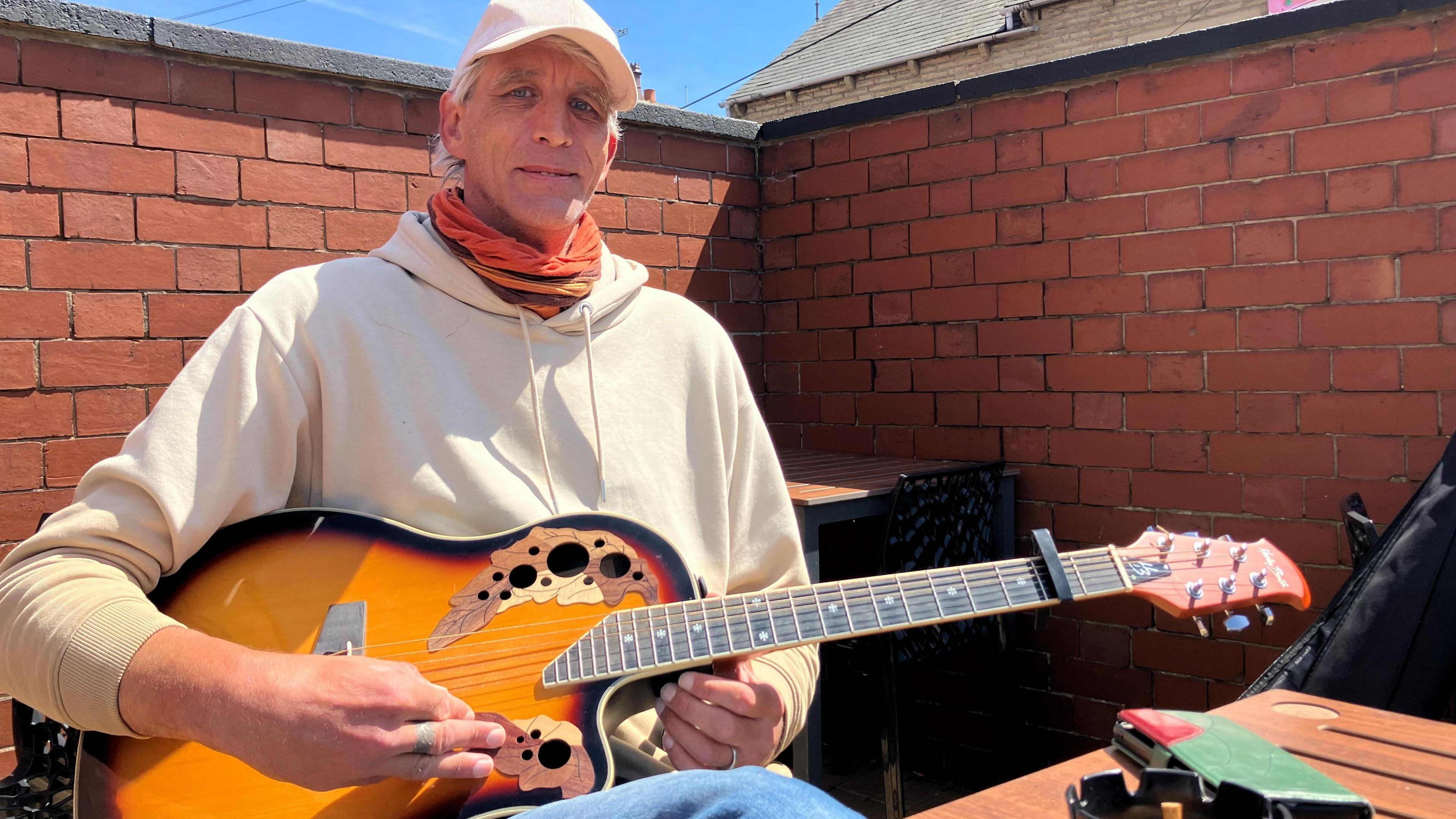 Matt Fenton playing a guitar