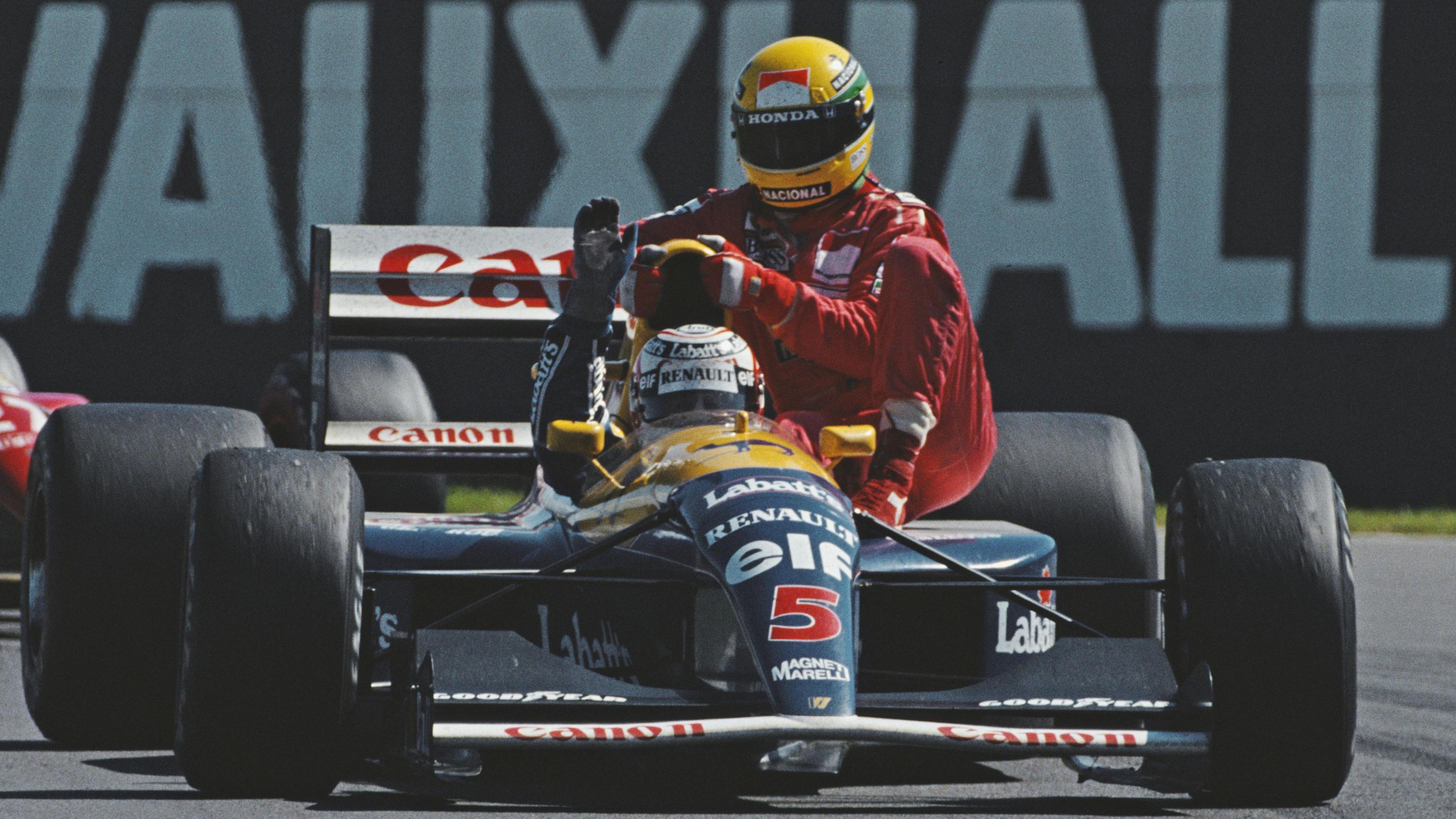 Ayrton Senna sits on race winner Nigel Mansell's Williams after he broke down on the final lap of the 1991 race at Silverstone