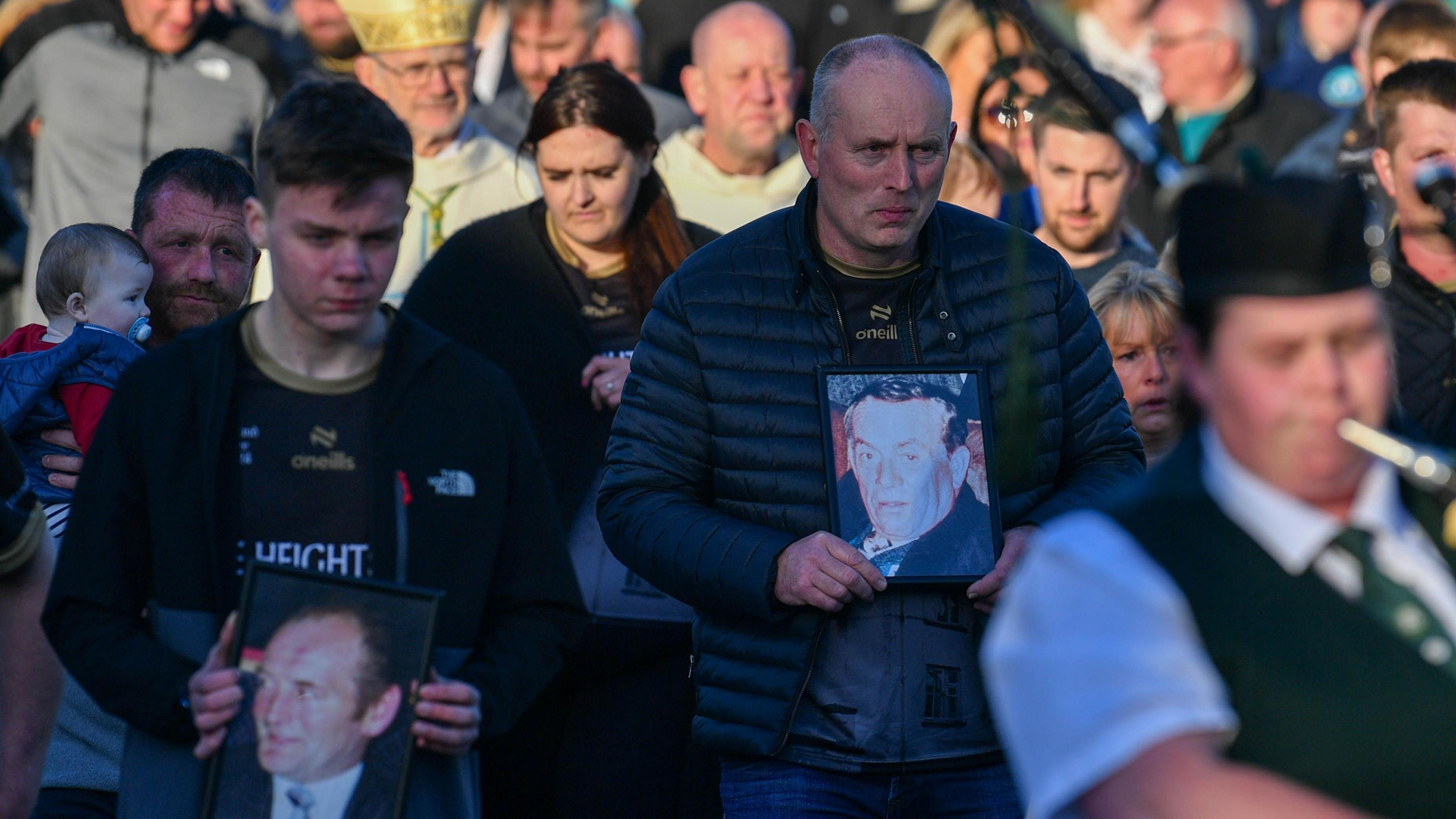 Families holding images of victims