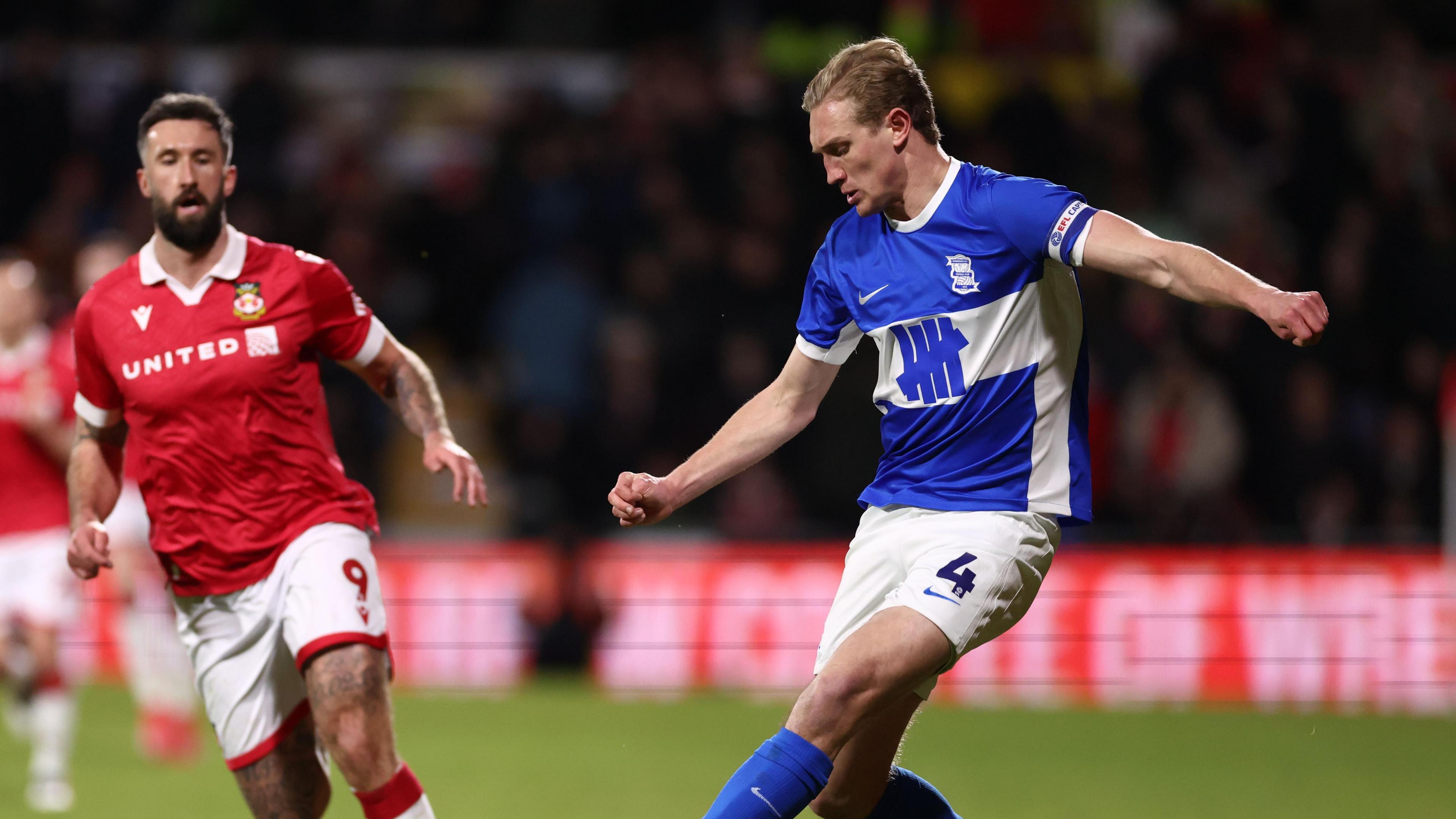 Birmingham City defender Christoph Klarer and Wrexham's striker Ollie Palmer at the Racecourse Ground.