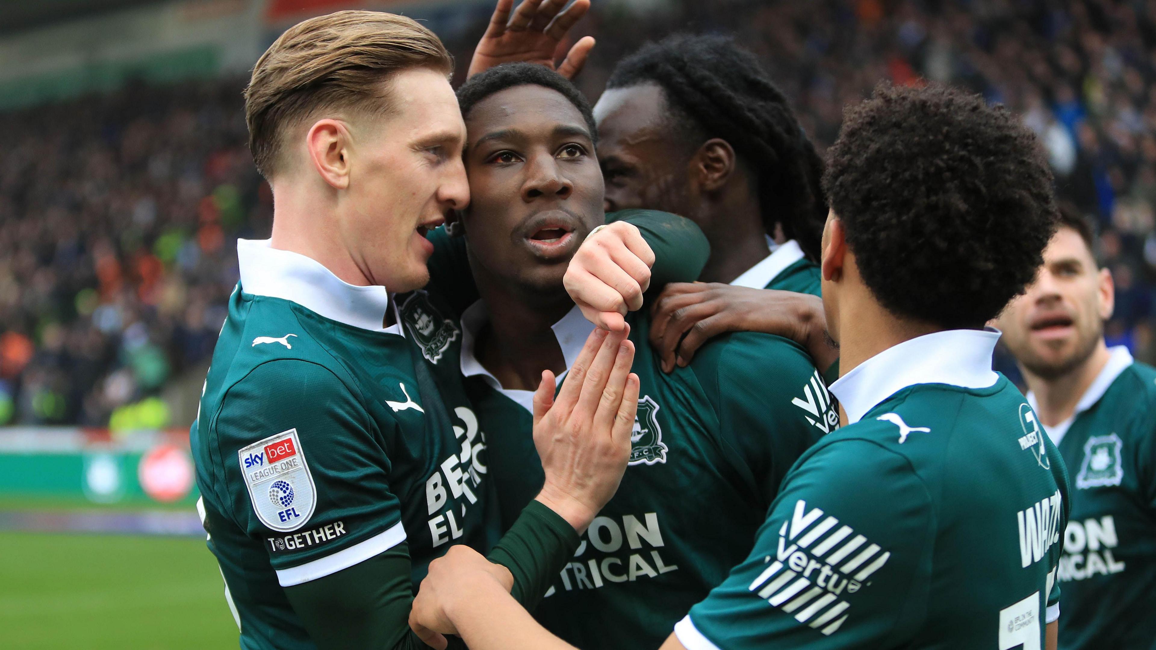 Bim Pepple (centre) celebrates scoring for Plymouth