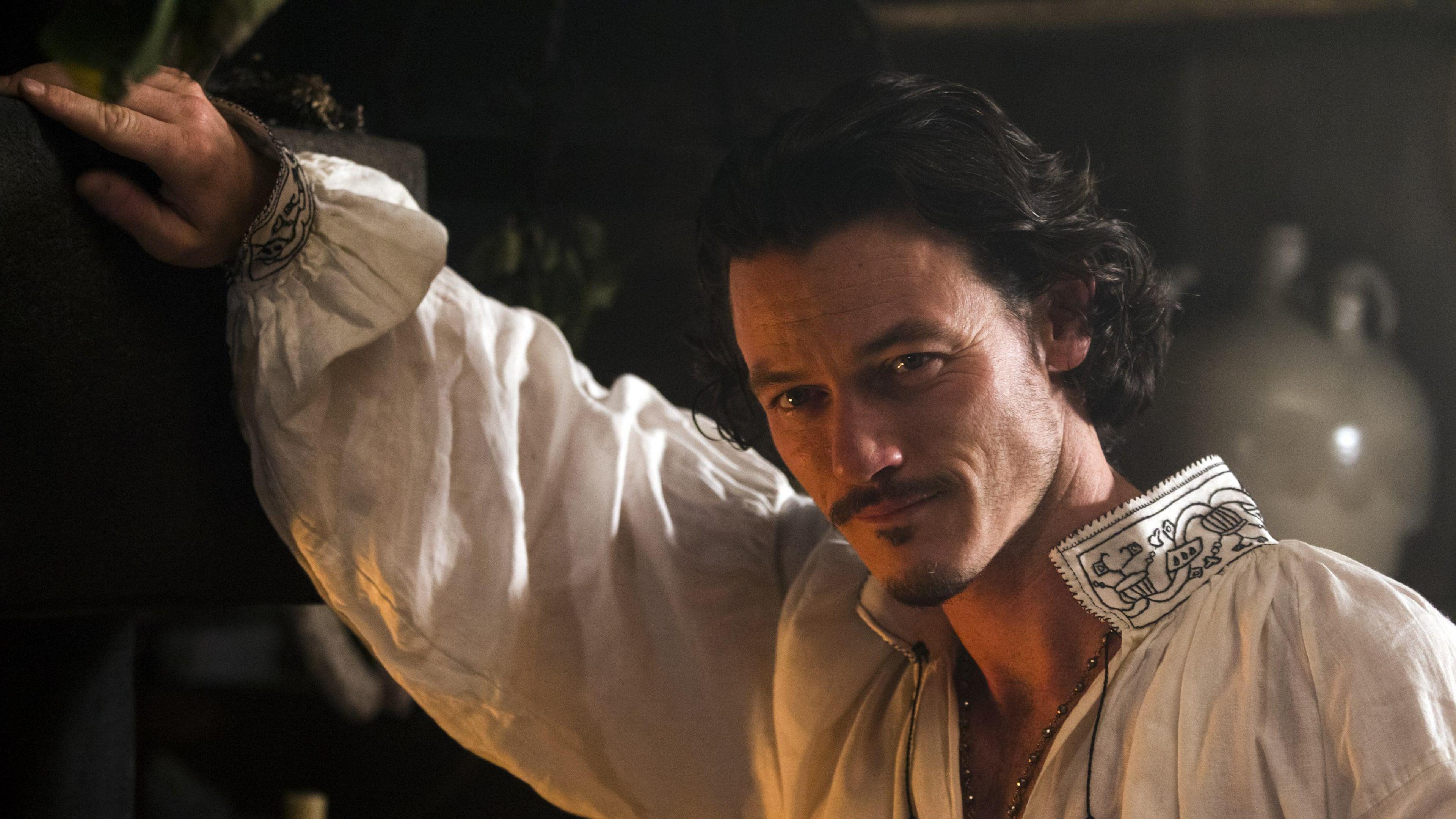 Luke Evans smiling in costume of Aramis in The Three Musketeers