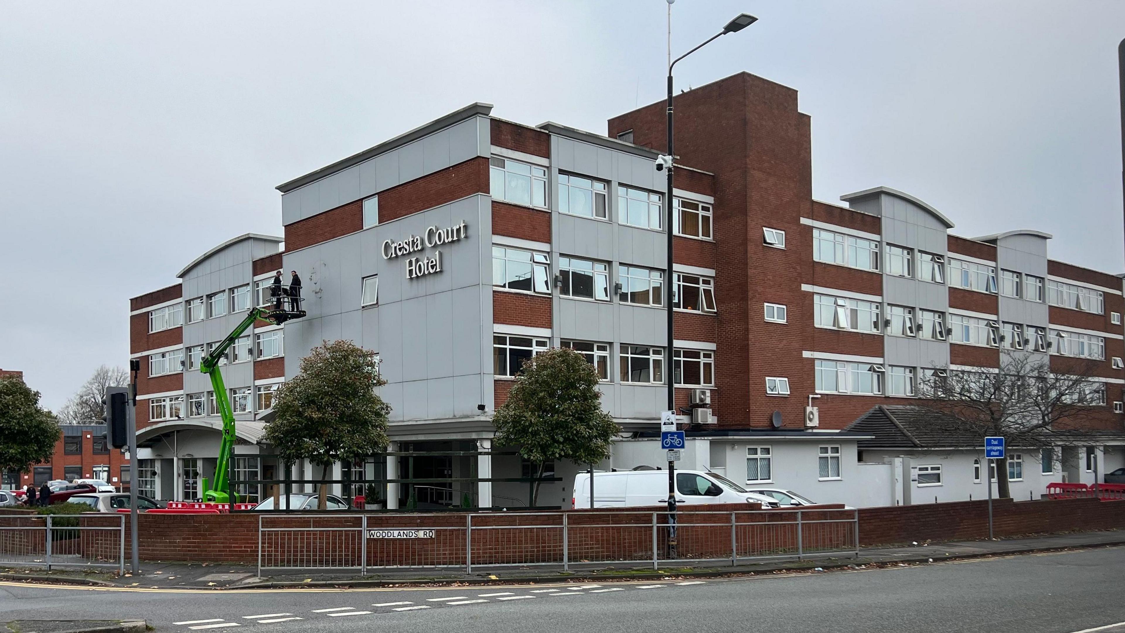 The four-storey brick and concrete Cresta Court Hotel in Altrincham was built in the 1970s. It is located at a busy junction on the edge of the town centre.