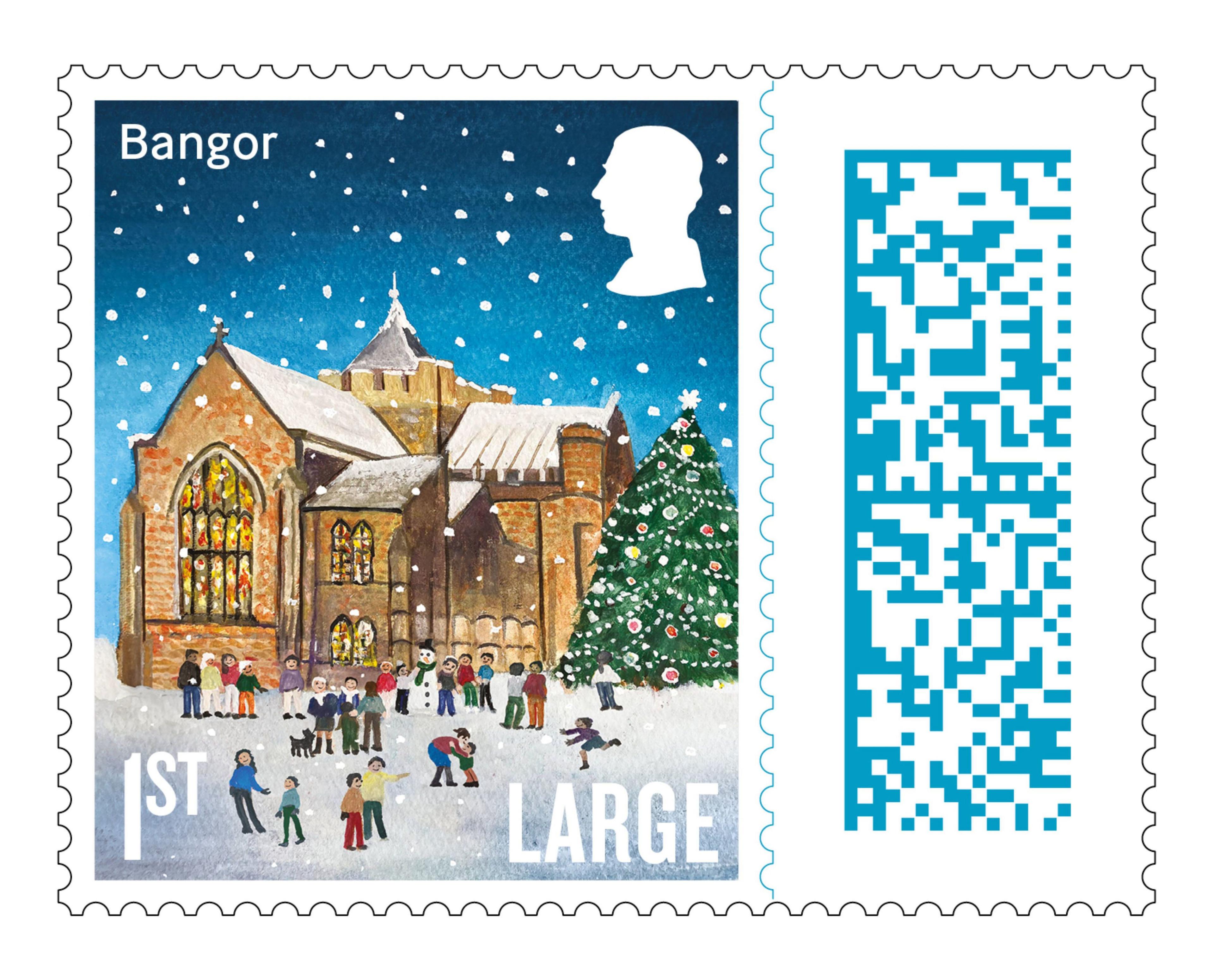 The stamp for Bangor. It is an illustration of St Deiniol's Cathedral - it has Bangor written at the top left hand corner, a silhouette of the King's head in the top right, Large is written in the bottom right and 1st in the bottom left. The scene is one of a brown Cathedral with stained glass windows. There are people playing the snow outside with a large Christmas tree to the right. 