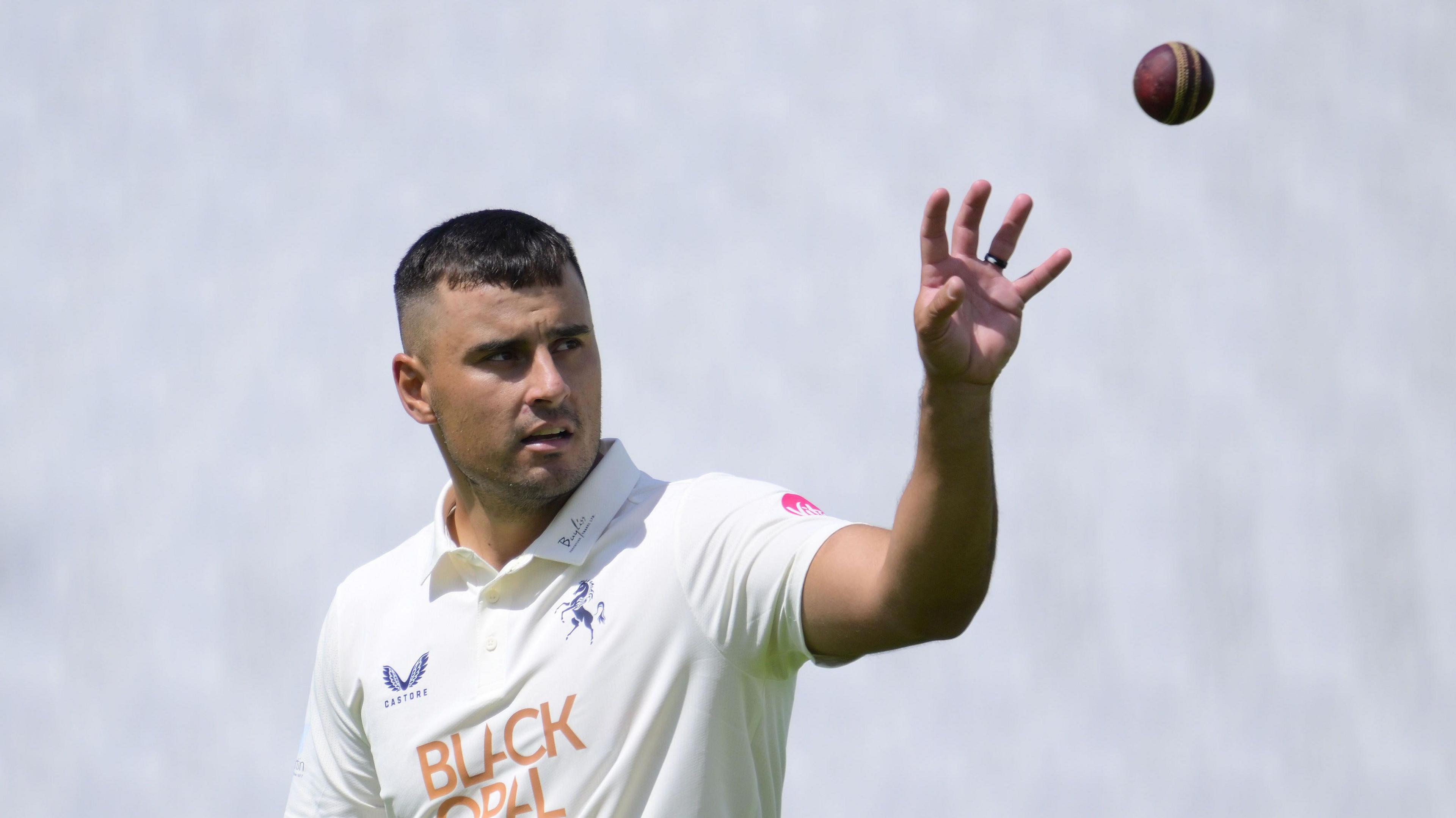 Beyers Swanepoel puts his left hand up ready to catch the ball as he prepares to bowl