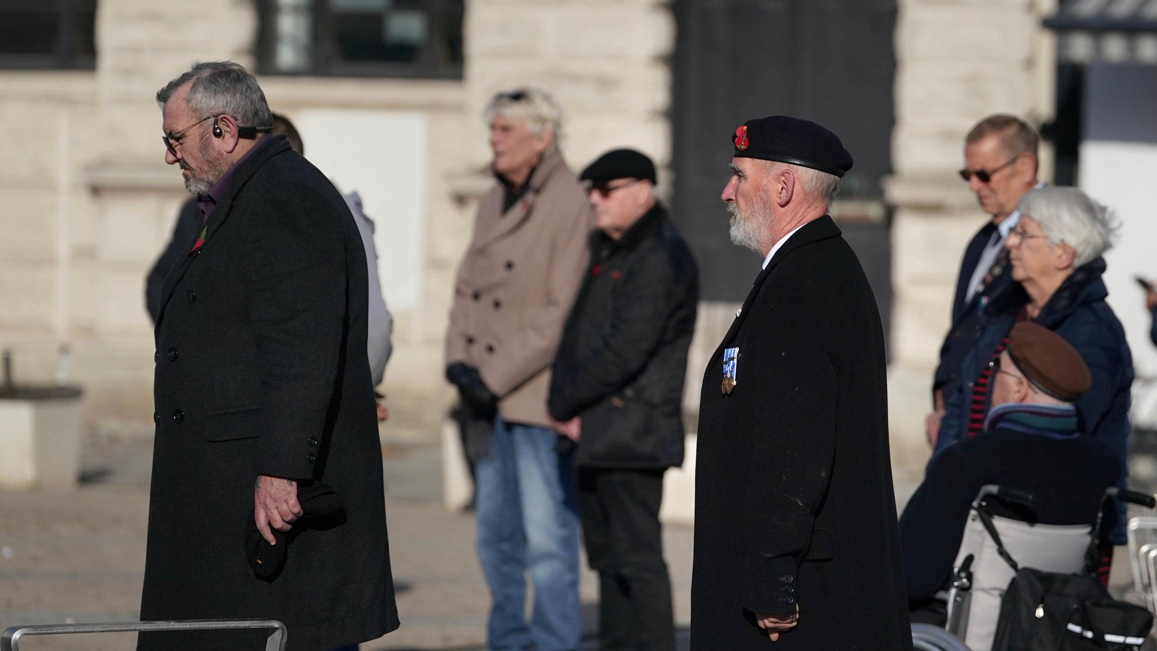 People stand by the First World War Soldier statue in Market Square in Dover for a two-minute silence to mark Armistice Day. 