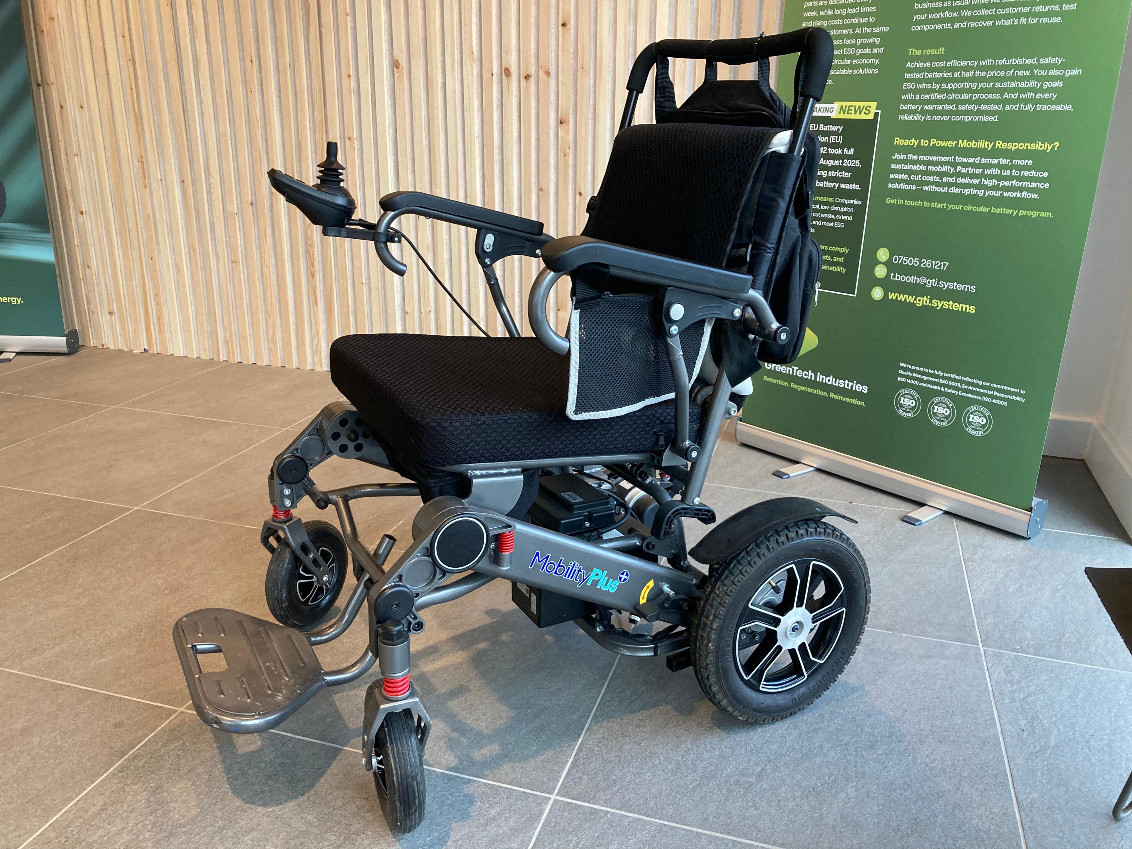 A wheelchair with an electric battery-powered motor.