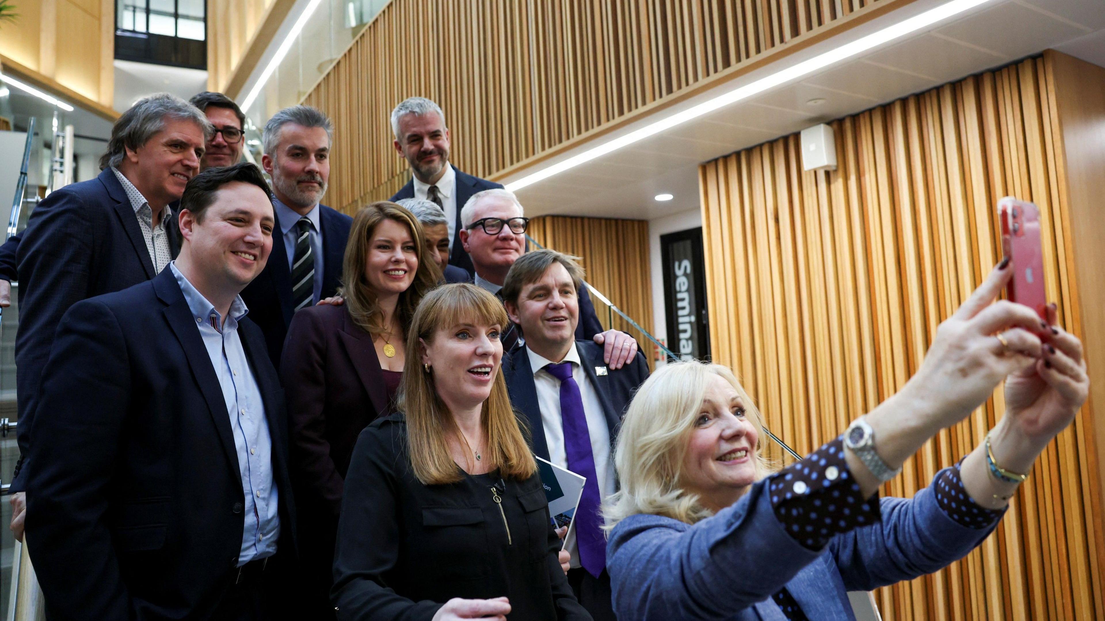 Angela Rayner poses for a group selfie with elected mayors from across England, all standing on a staircase.