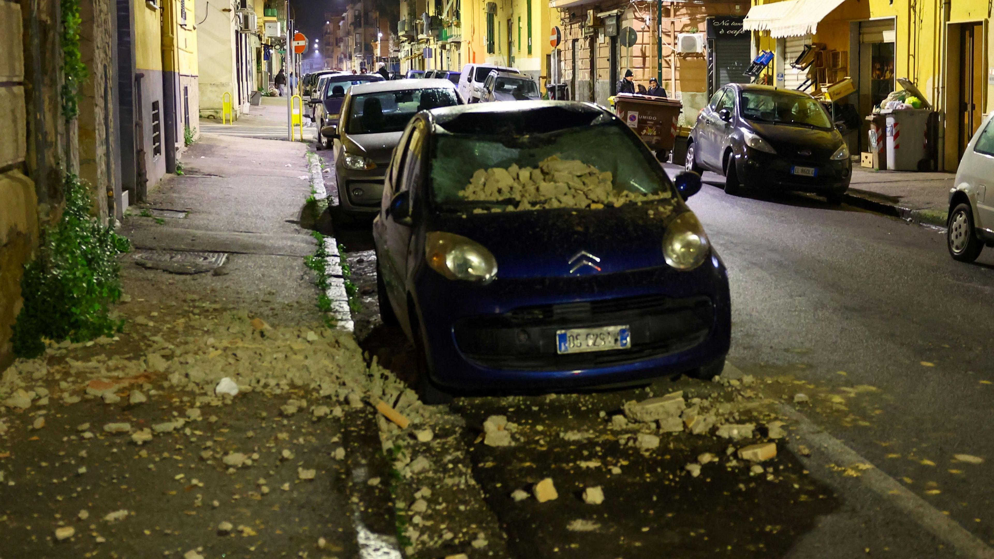 A car damaged by rubble caused by the earthquake.