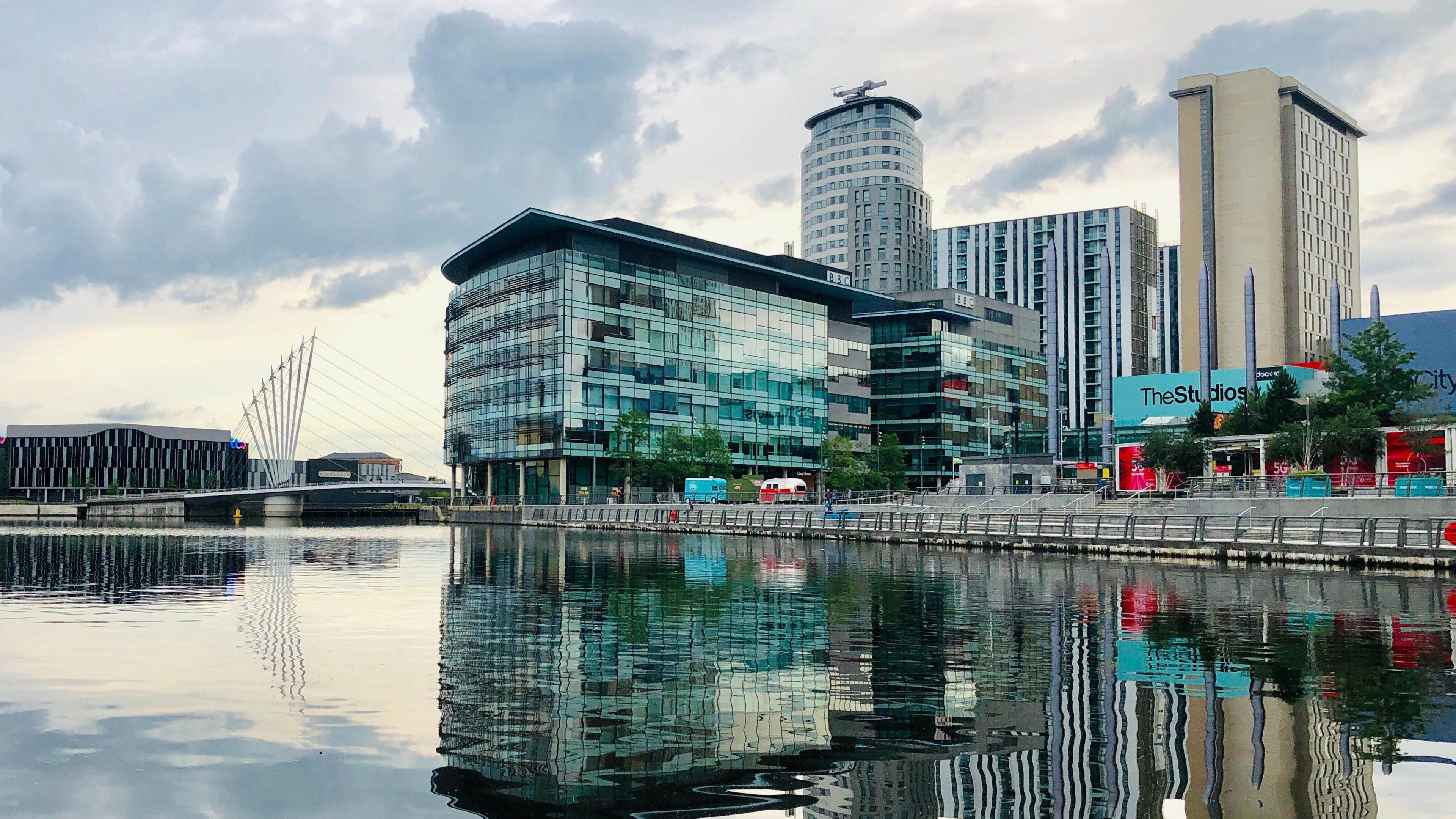 MediaCityUK at Salford Quays features large office buildings, broadcast studios, bars and restaurants next to the Manchester Ship Canal.