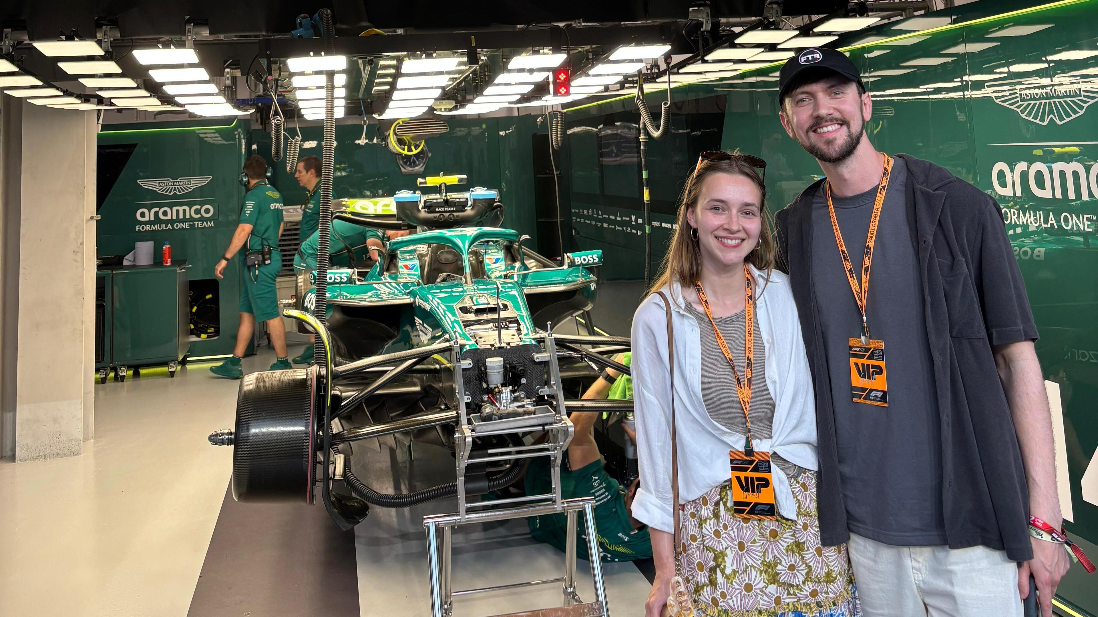 Brandon Burgess posing for a picture with his girlfriend in the Aston Martin garage in Saudi Arabia