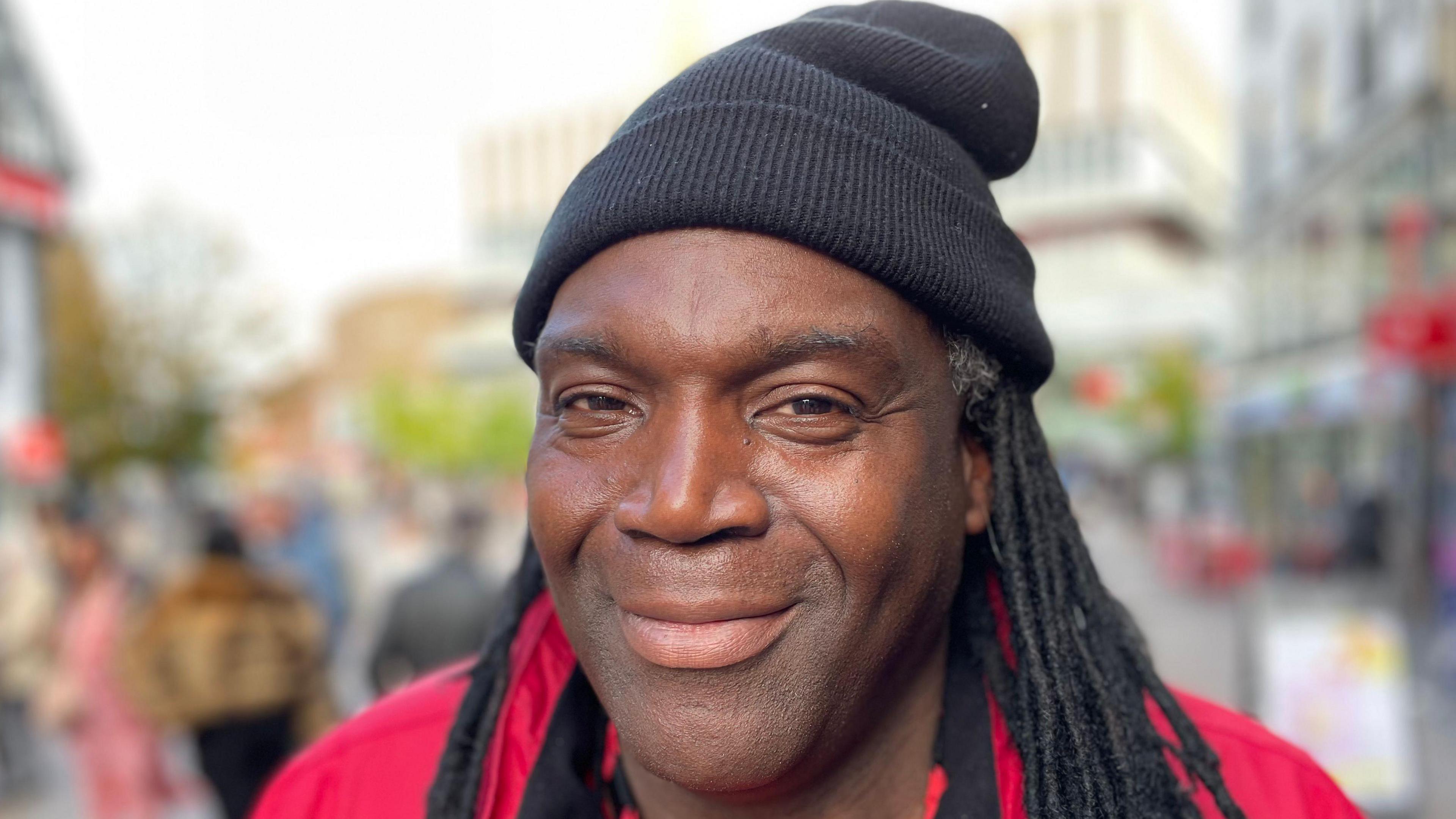 Clifton wearing a red uniform and a woolly hat