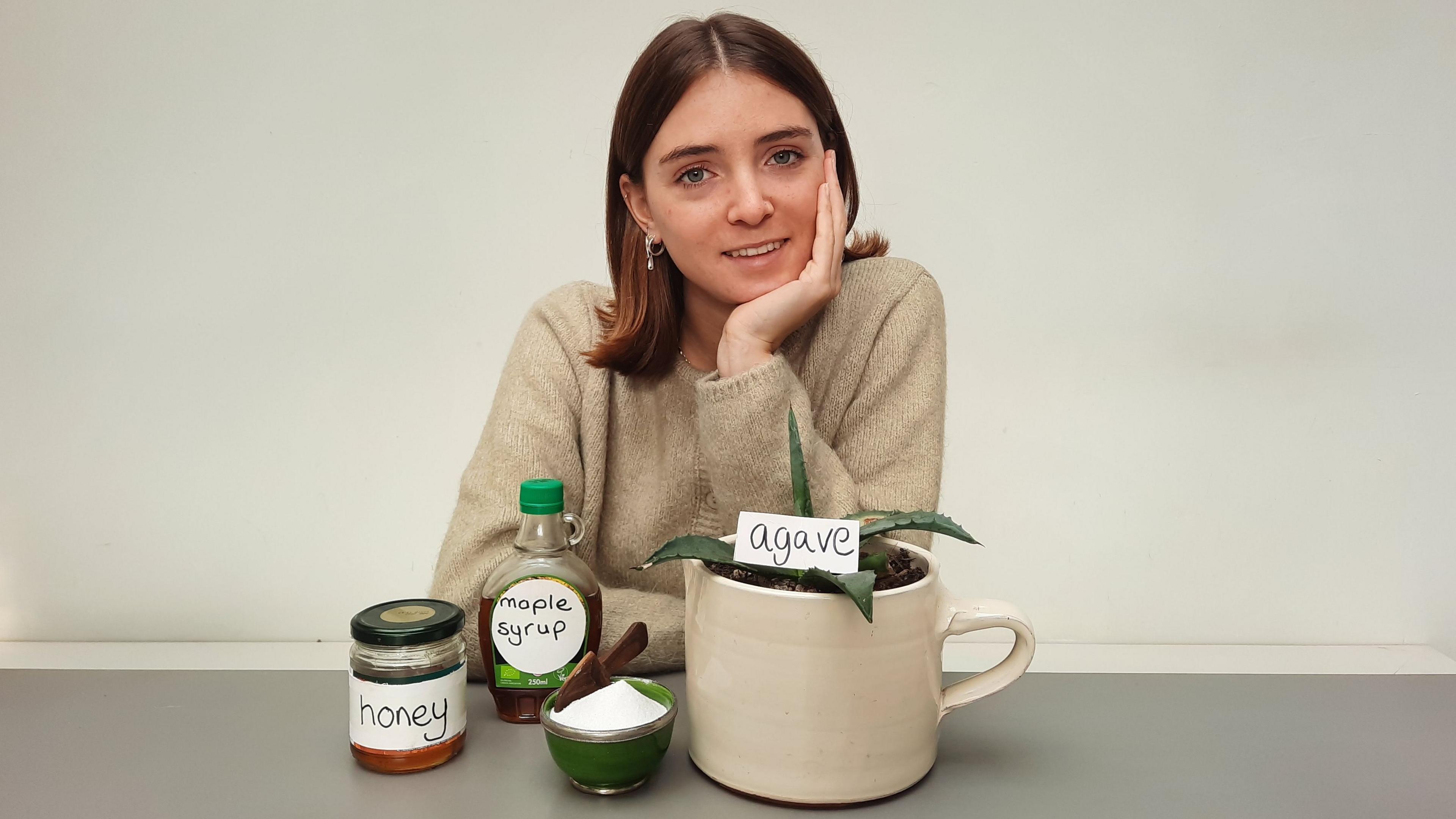 The author Lottie Savage with bottles of honey and agave nectar.
