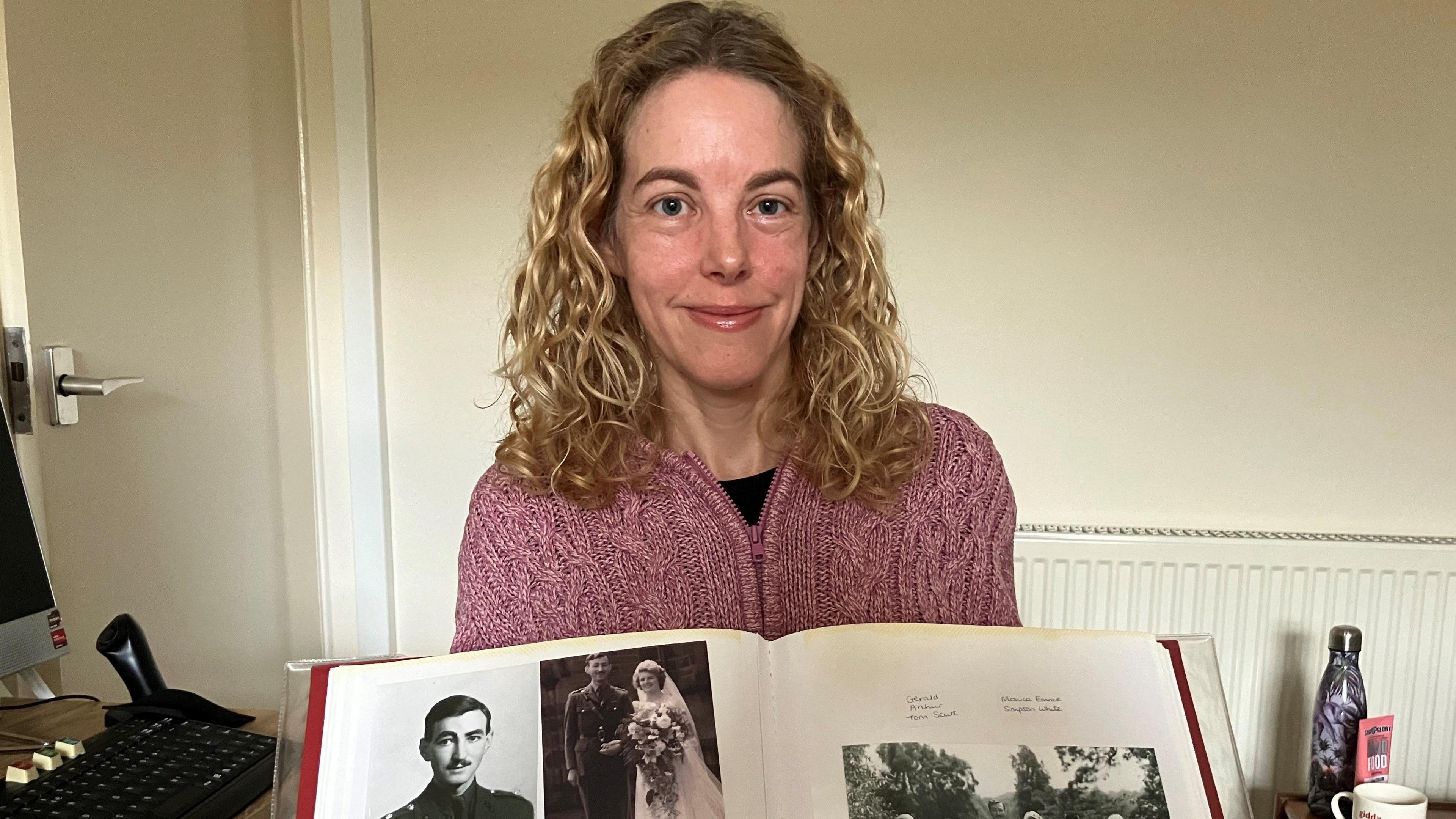 Anna with a photo album which features her grandparents