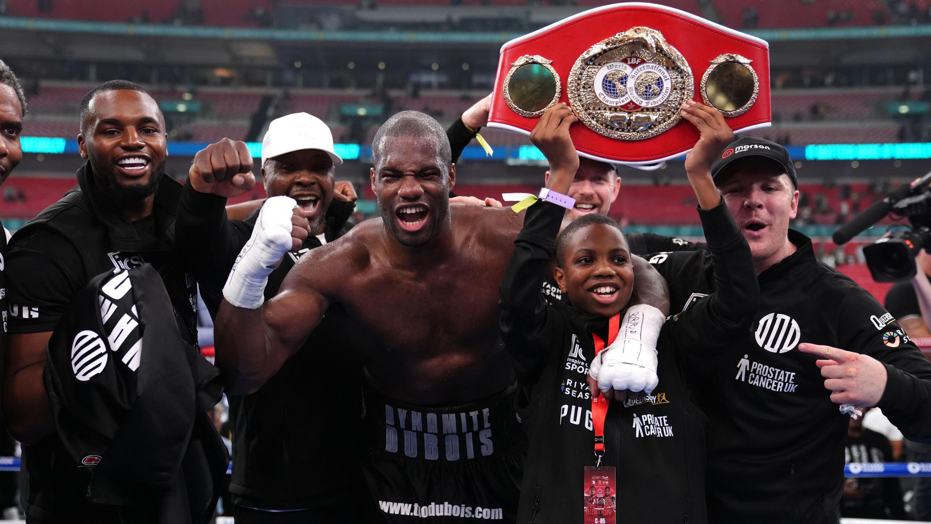 Daniel Dubois celebrates with team in the ring