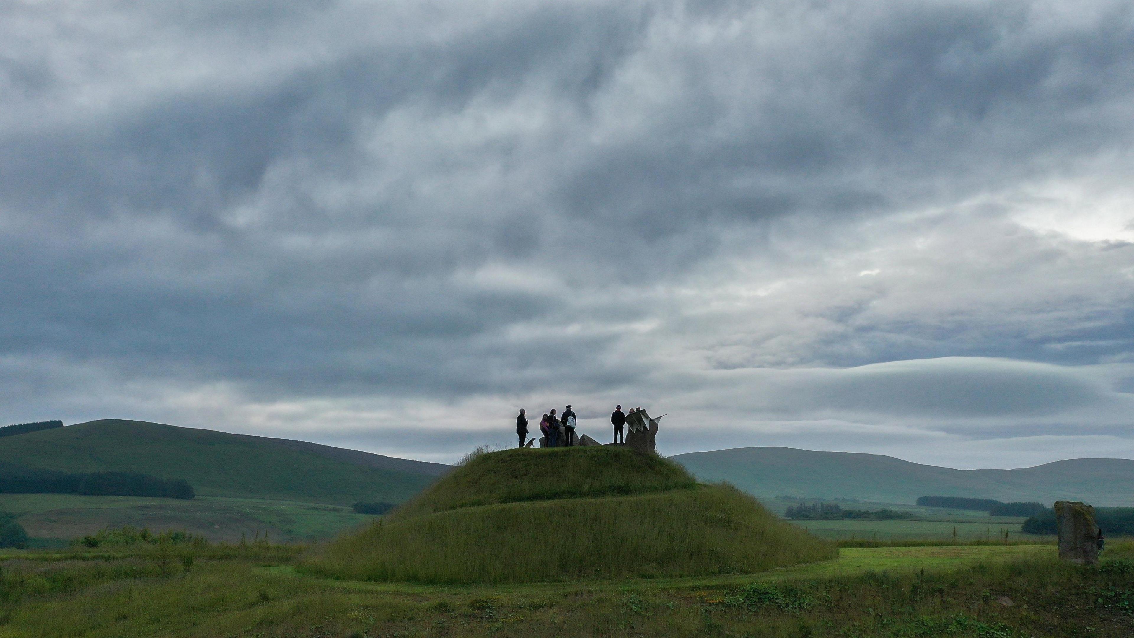 People on a hill at the artwork