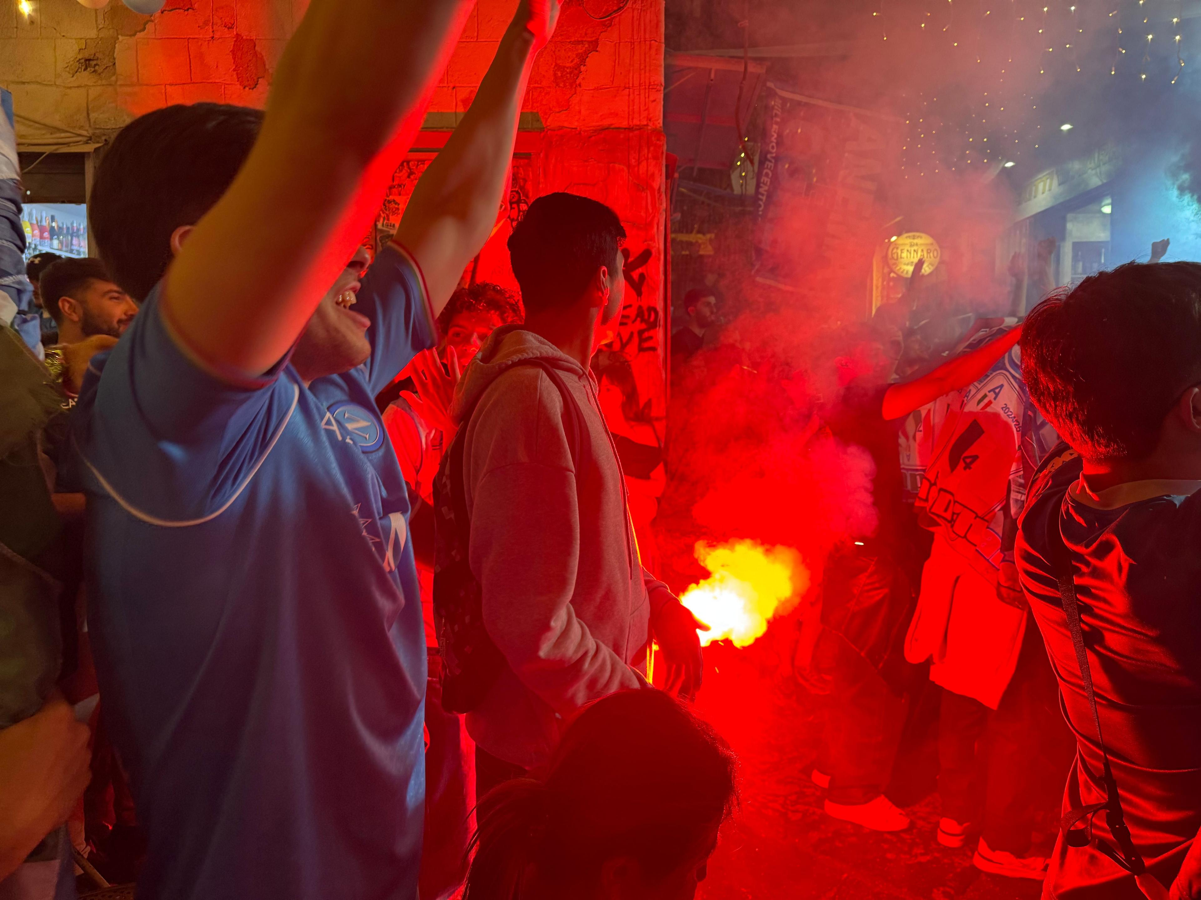 Fans with a flare in the street