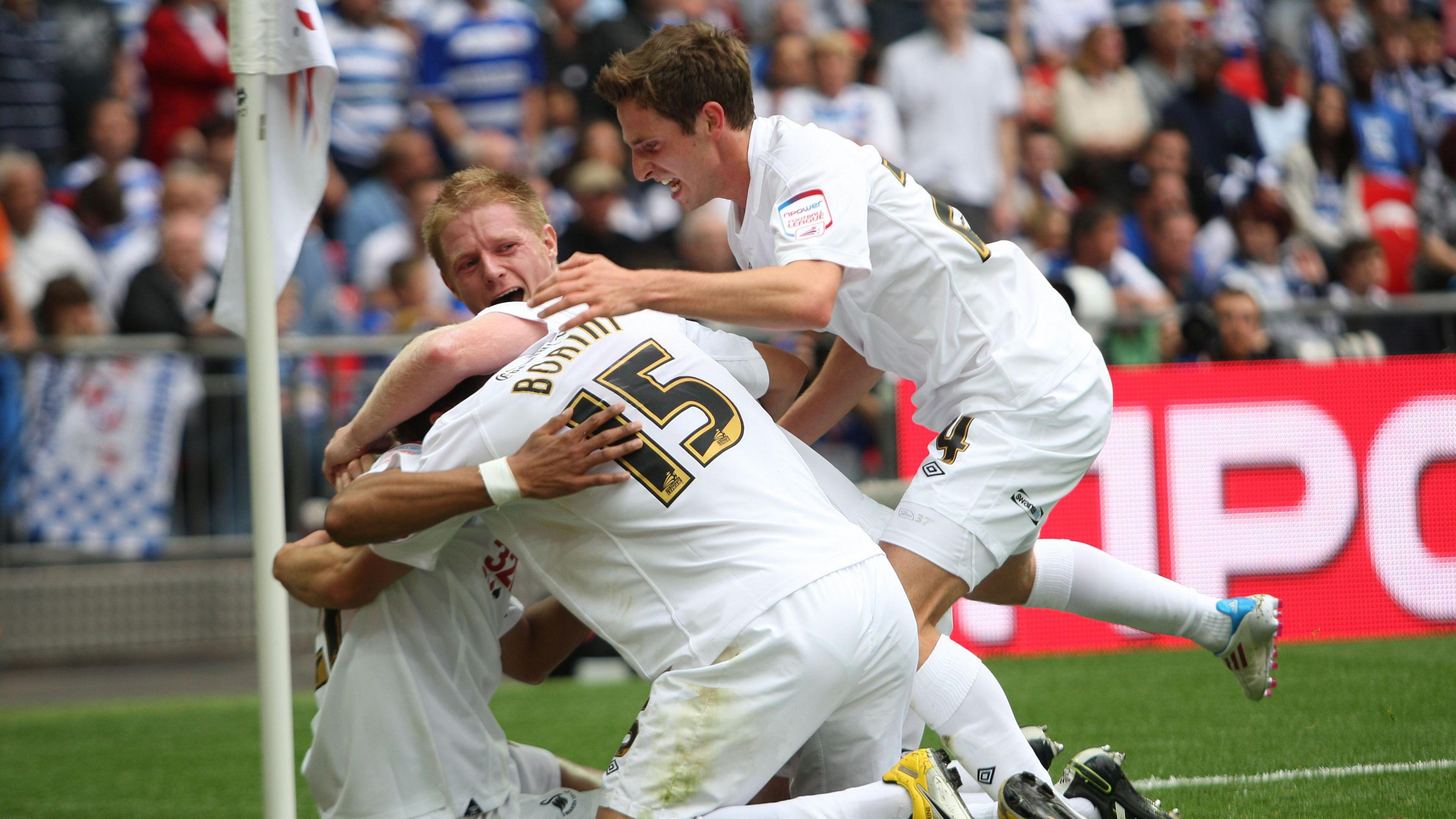 Joe Allen jumps down to join celebrating Alan Tate, a sat Scott Sinclair, and - with his back to the camera - Fabio Borini