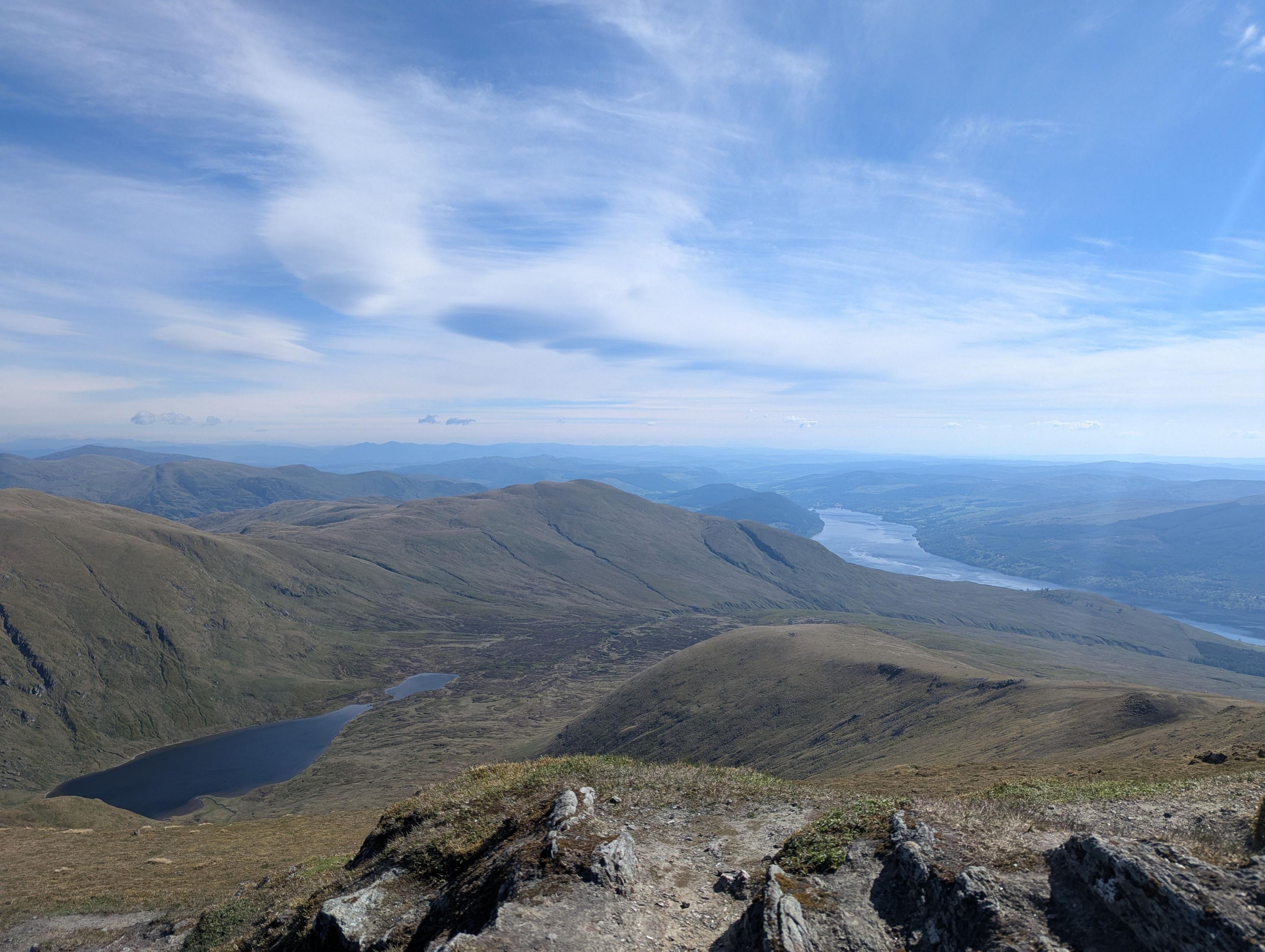 A view from the top of Ben Lawers, with hills, rivers and clouds all visible