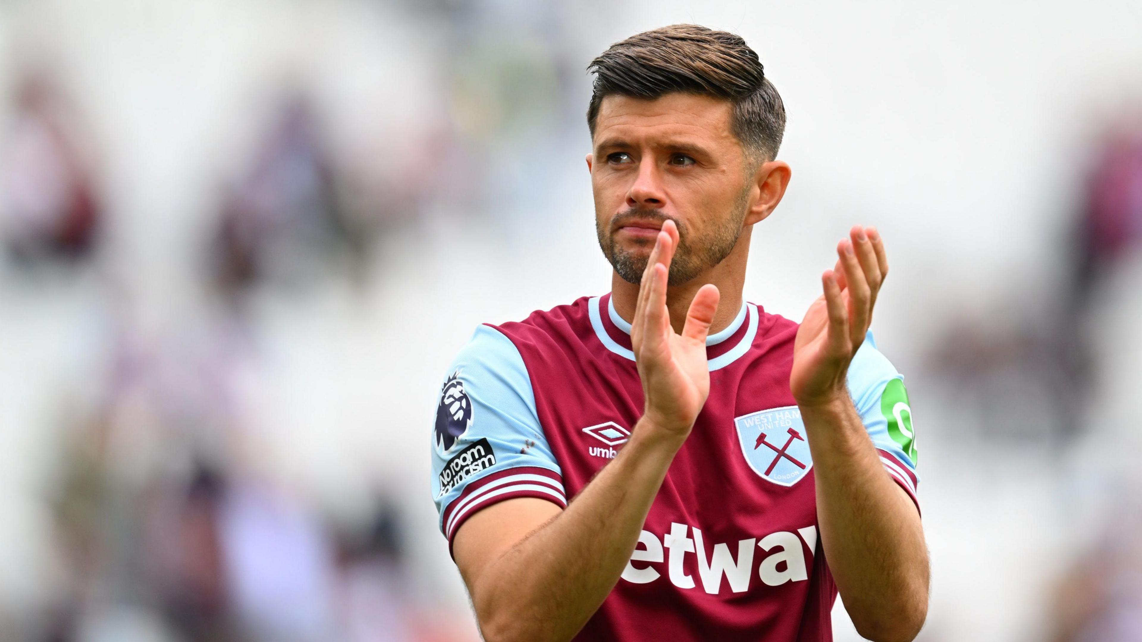 Aaron Cresswell claps the crowd at the end of his final game for West Ham