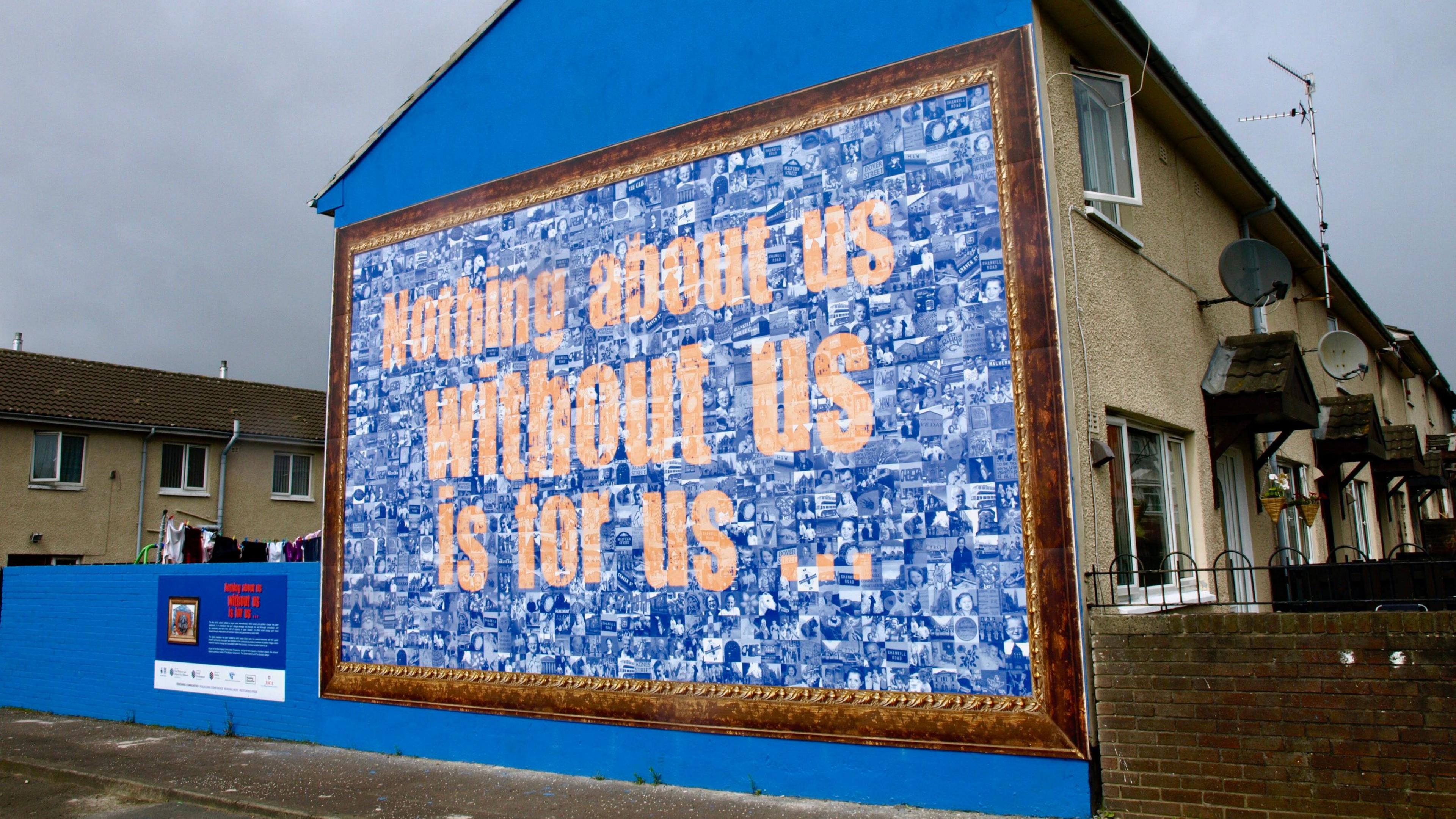 A mural in the Shankill area of west Belfast showing a mosaic of images in blue hues alongside yellow text which reads, "Nothing about us, without us, is for us"