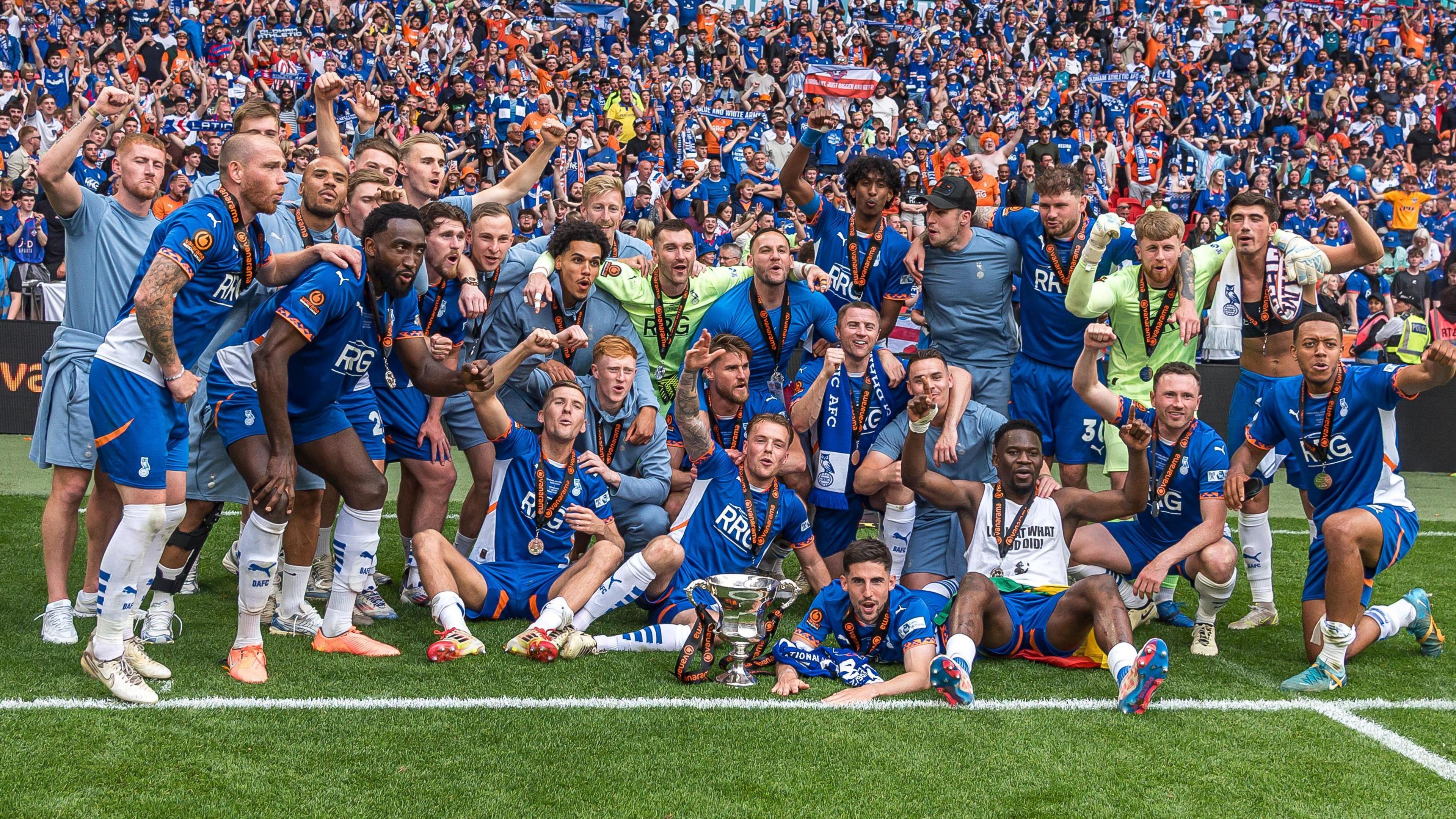 Oldham Athletic players observe pinch their fans astatine Wembley aft winning nan 2024-25 National League play-off final