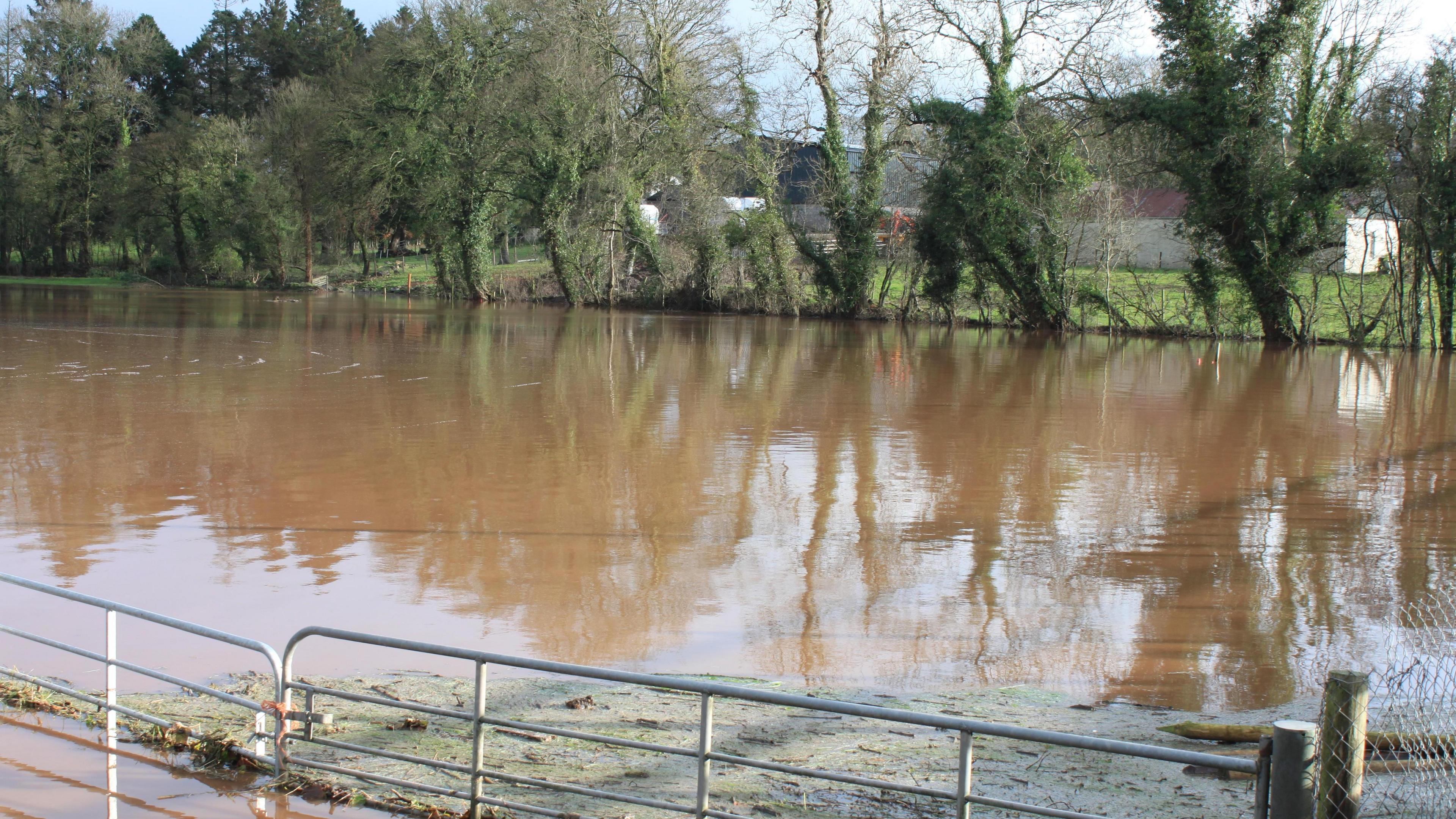 The A5 road from Ballygawley Roundabout with the fields flooded on both sides of the road