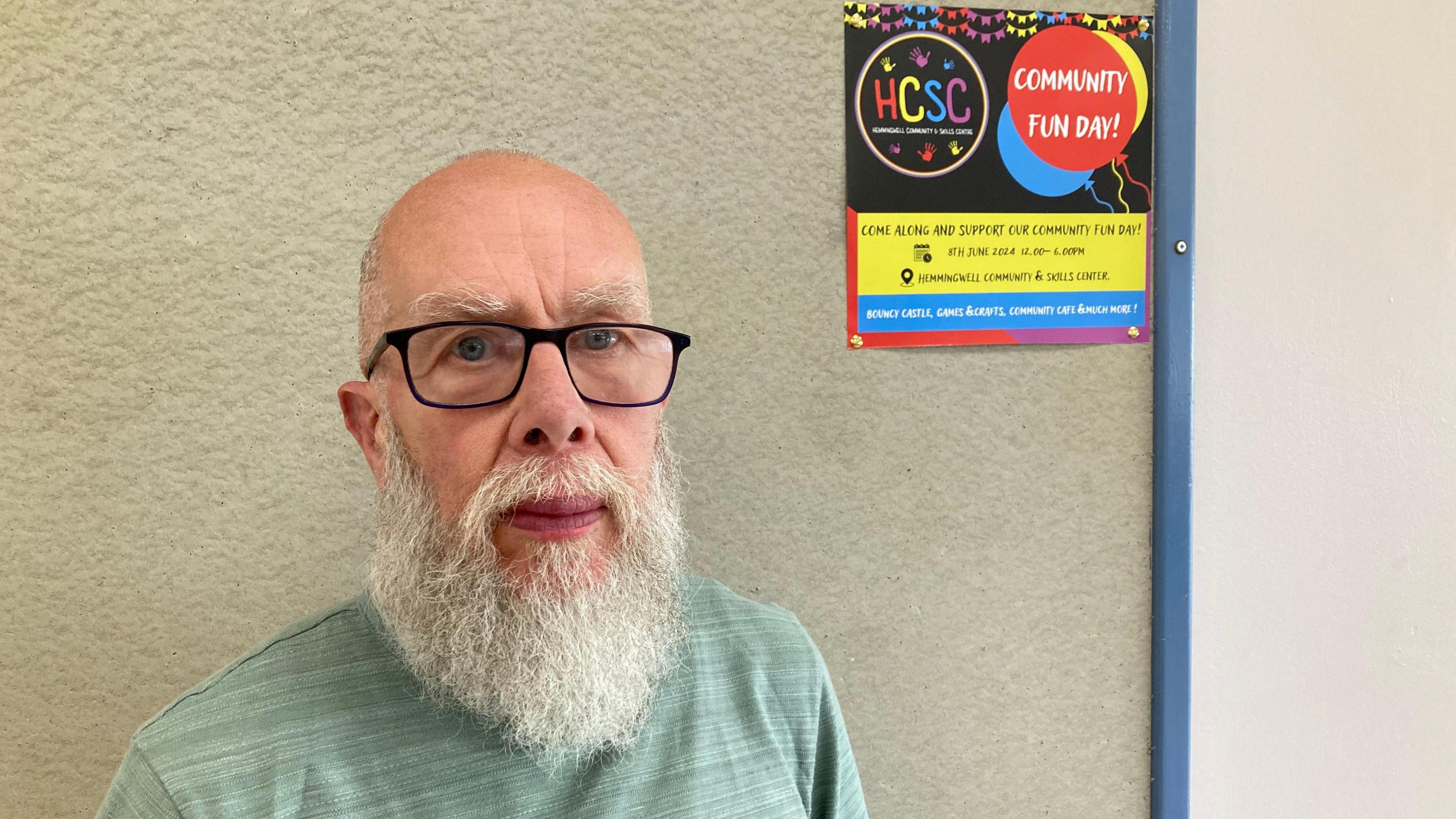 Martin Jones with long white beard and glasses wearing a green top