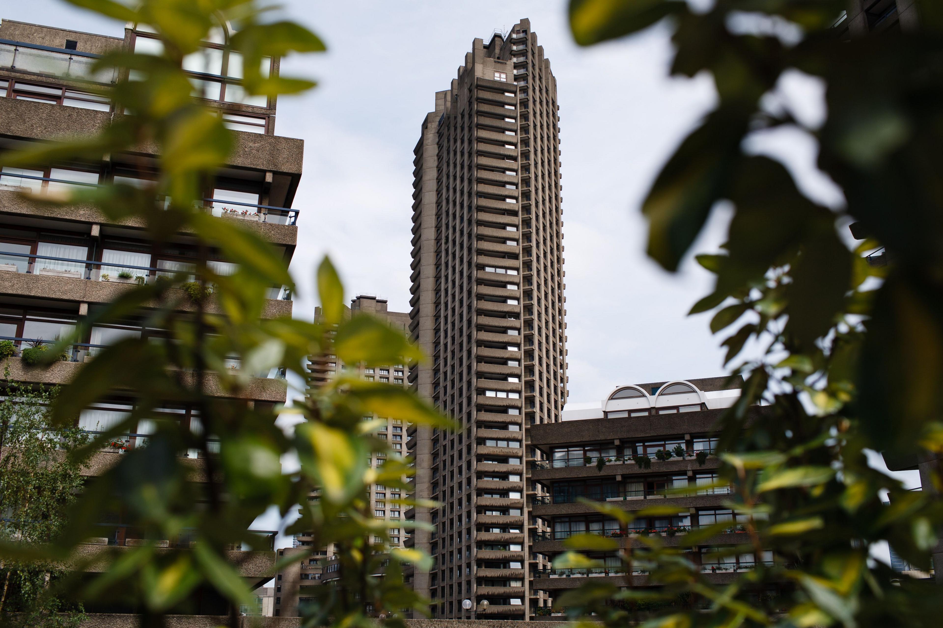 One of the Barbican towers surrounded by other parts of the estate seen through green vegetation