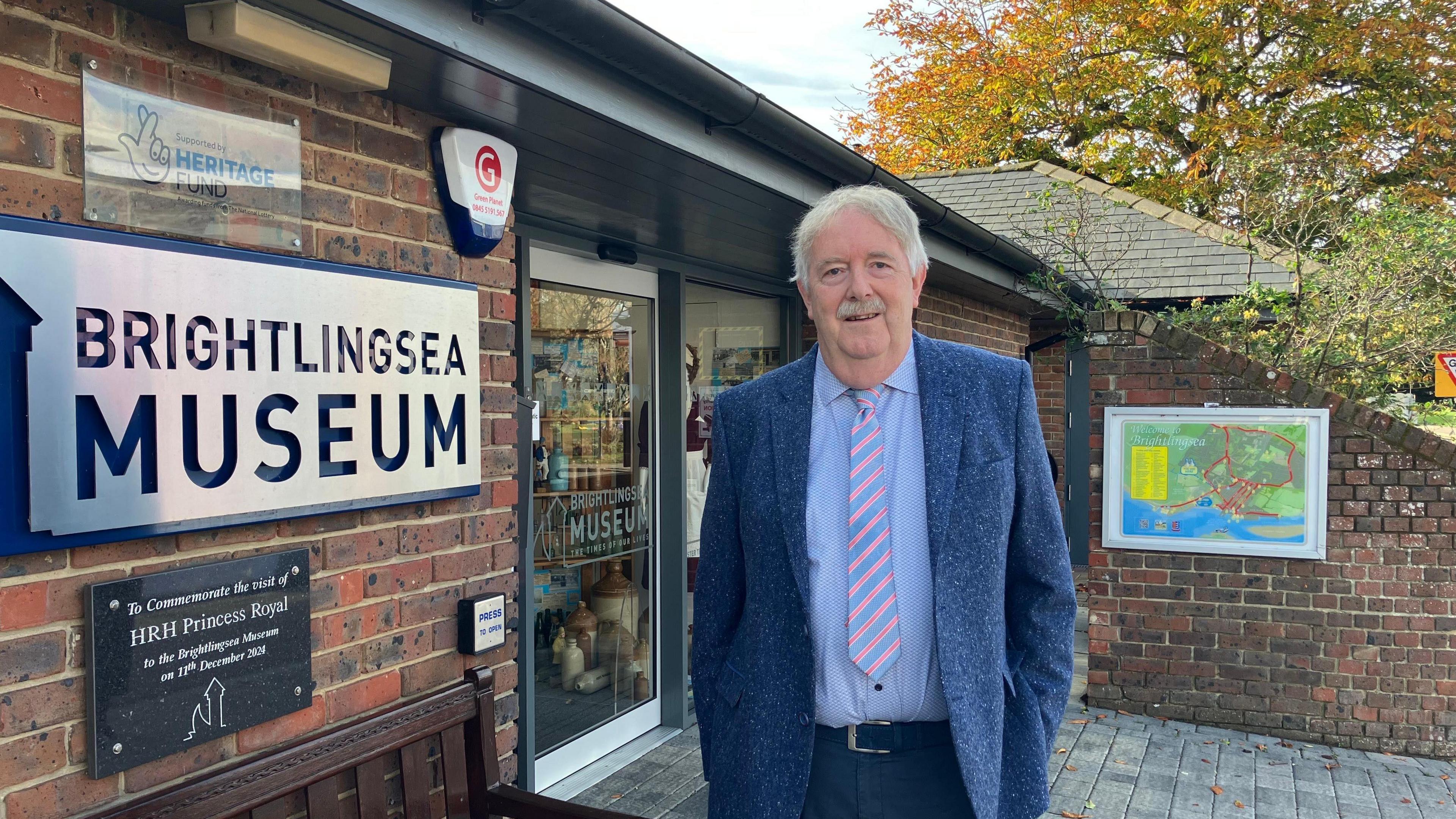 A picture of Richard Dove standing outside the entrance of Brightlingsea Museum