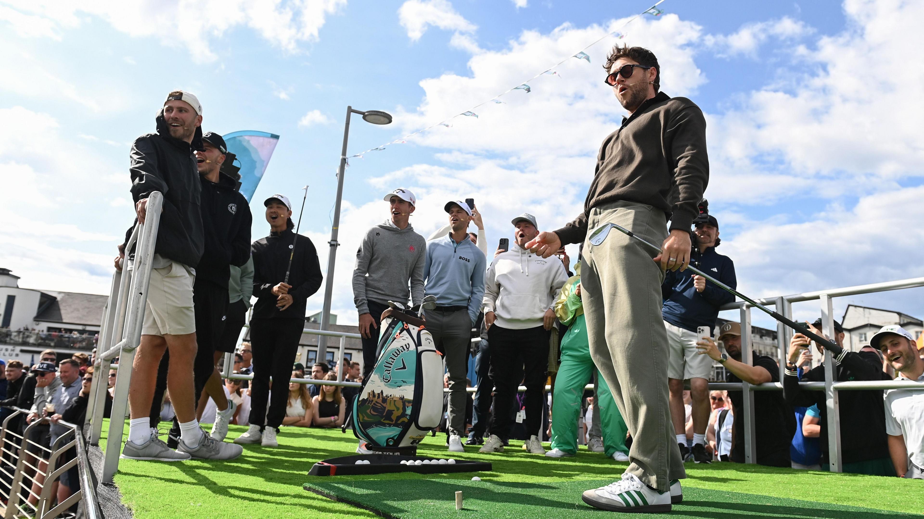 Niall Horan chips the ball into the harbour at Royal Portrush