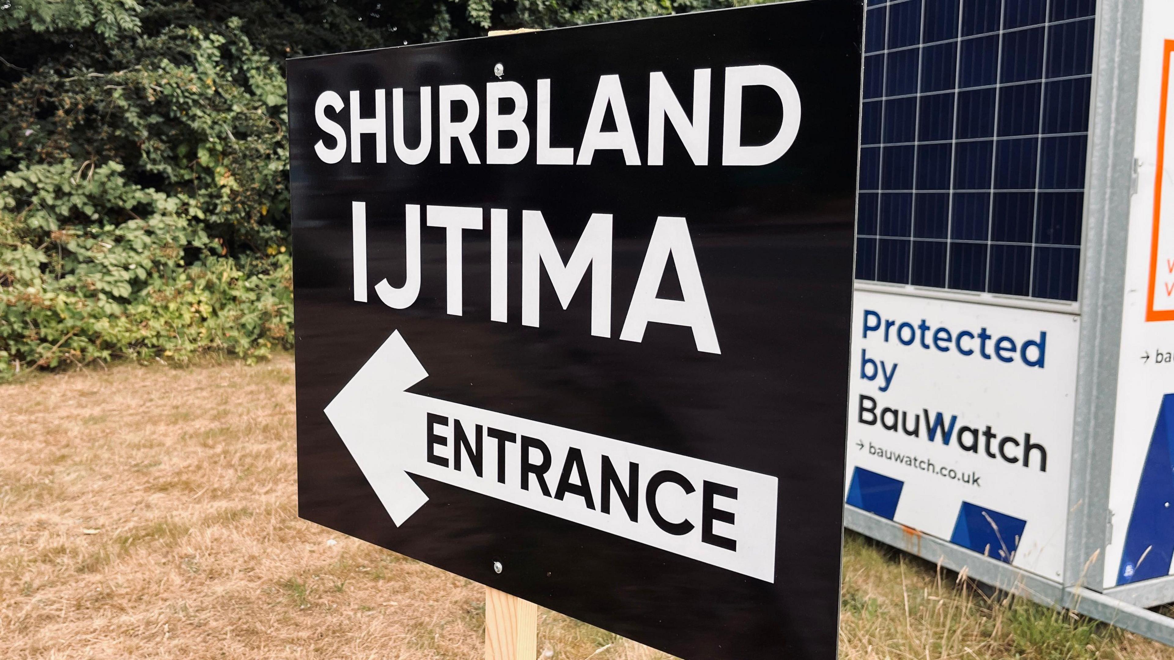 A black and white sign that reads Shrubland Ijtima Entrance. 