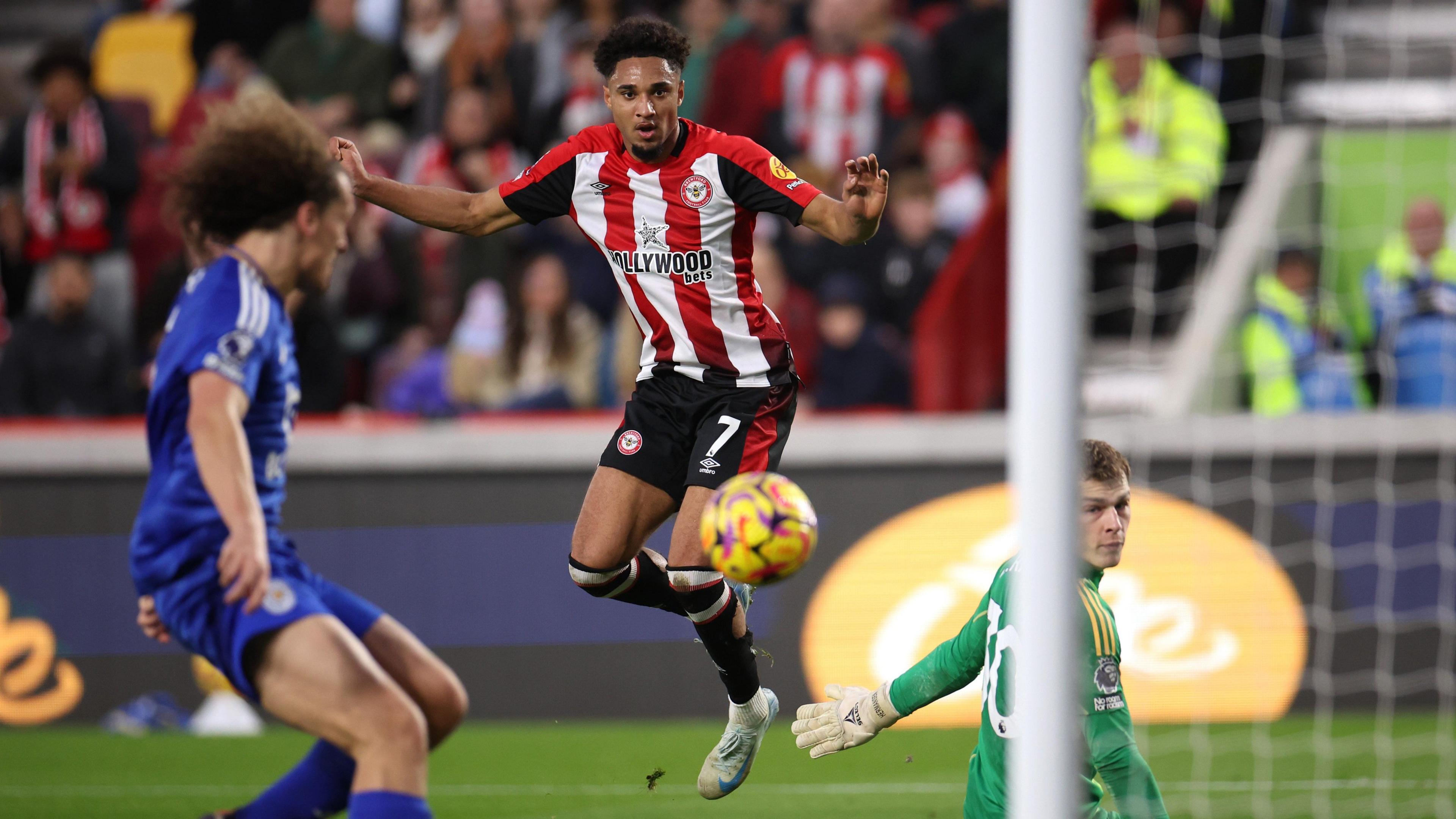 Kevin Schade chips the ball over Mads Hermanson to score his second goal in Brentford's win over Leicester.