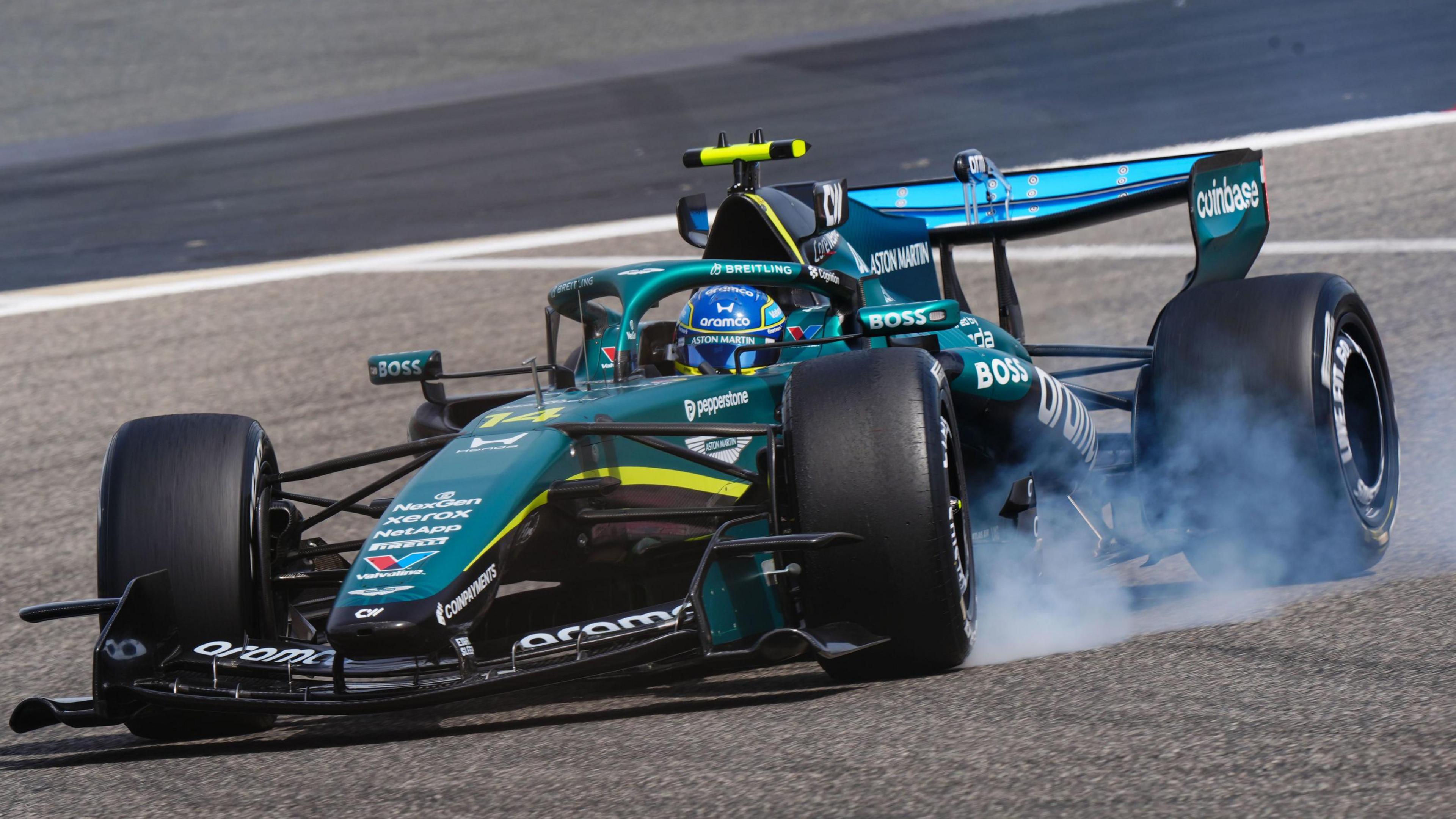 Aston Martin's Fernando Alonso locks up a tyre during pre-season testing in Bahrain