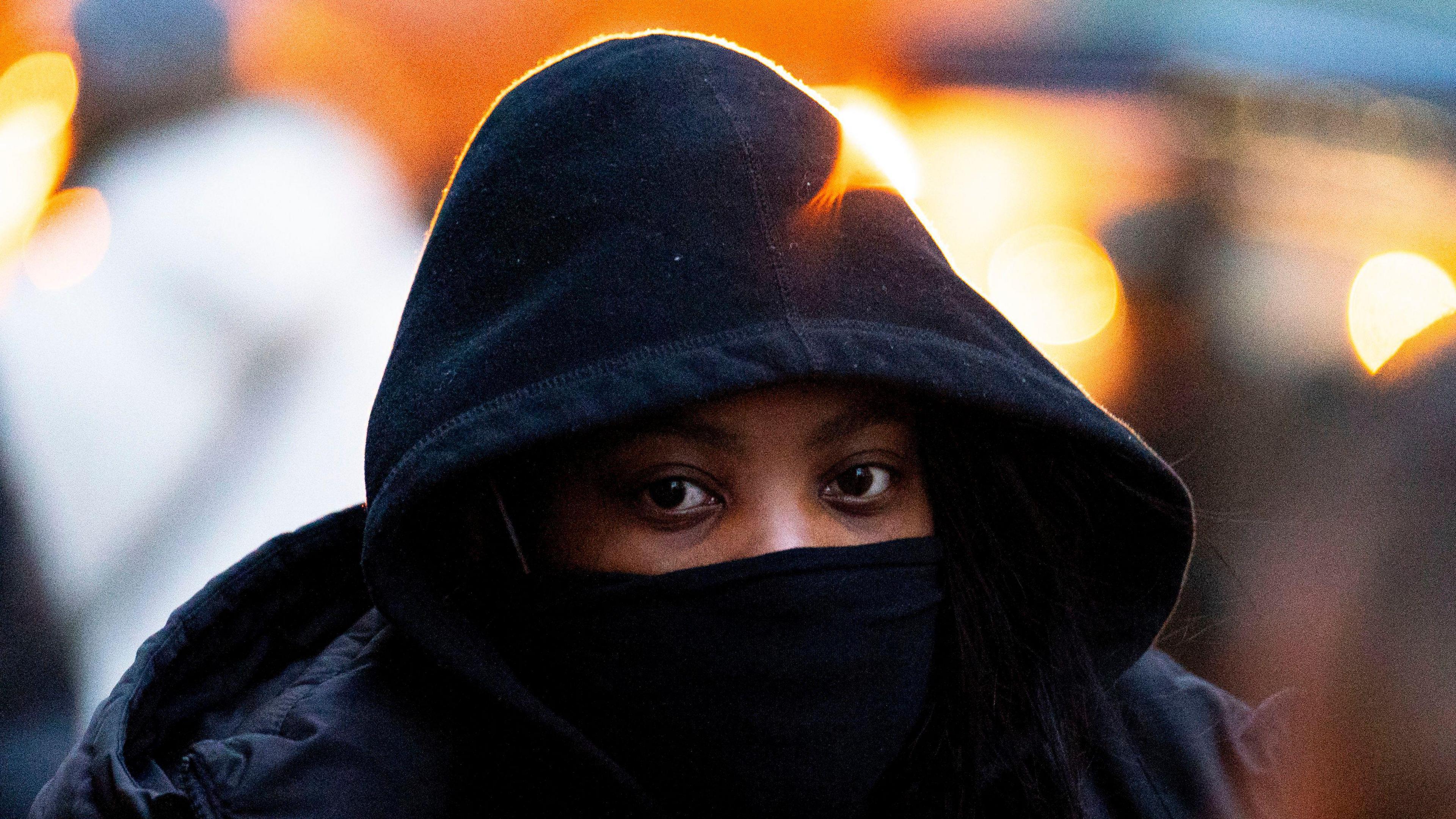 Deveca Rose arrives at the Old Bailey, central London, wearing a black coat with the hood pulled up and a black scarf over her mouth 