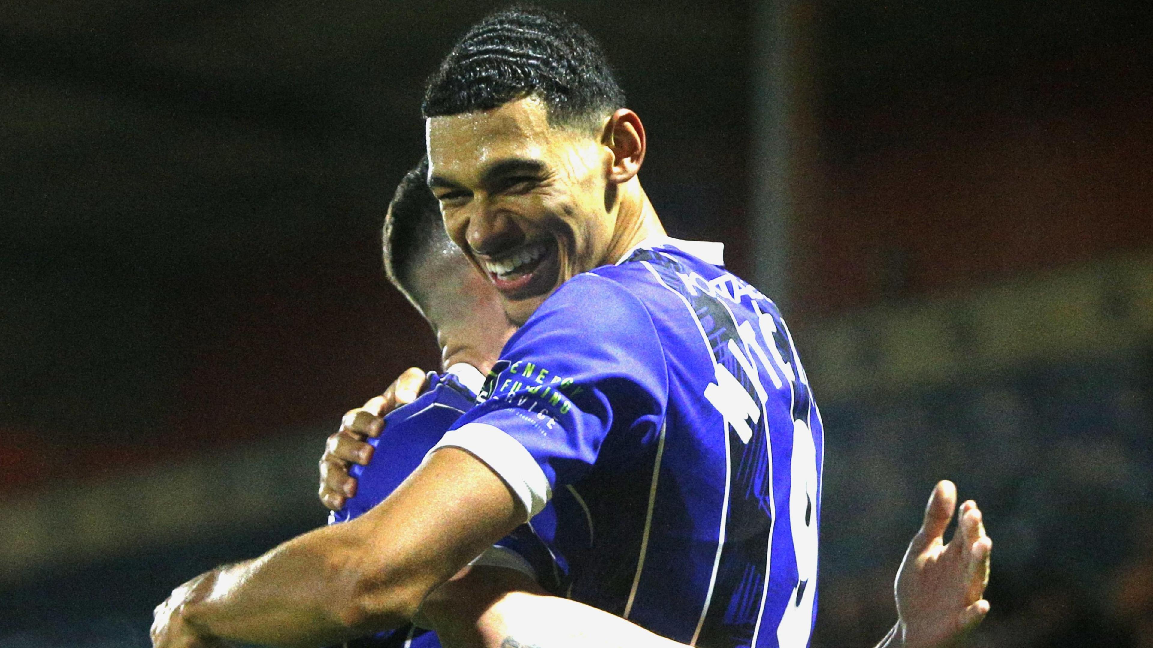Kairo Mitchell celebrates scoring a goal for Rochdale in their 3-0 home win over Altrincham in November 2023