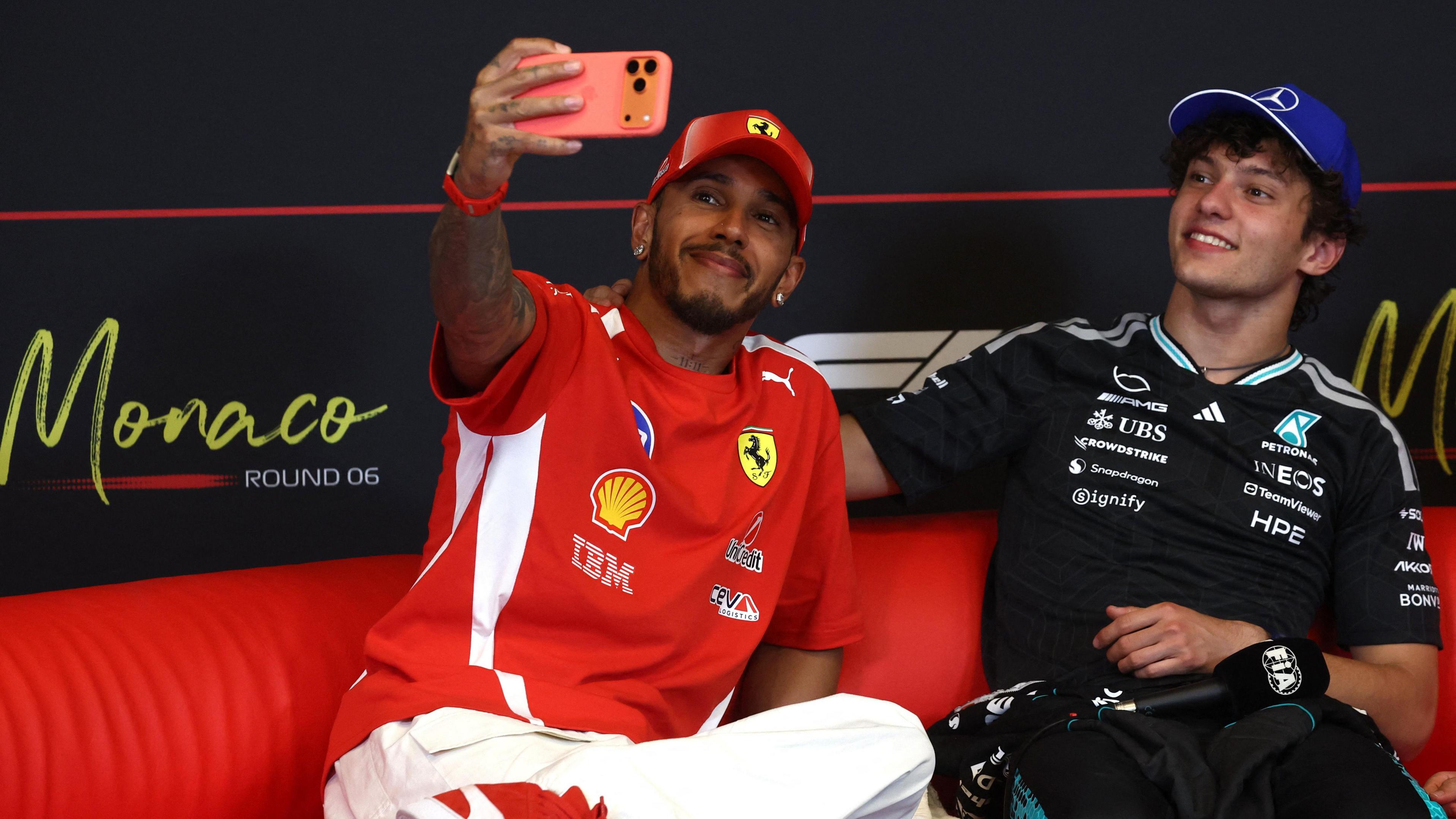 Lewis Hamilton takes a picture with race winner Kimi Antonelli in the post-race news conference 