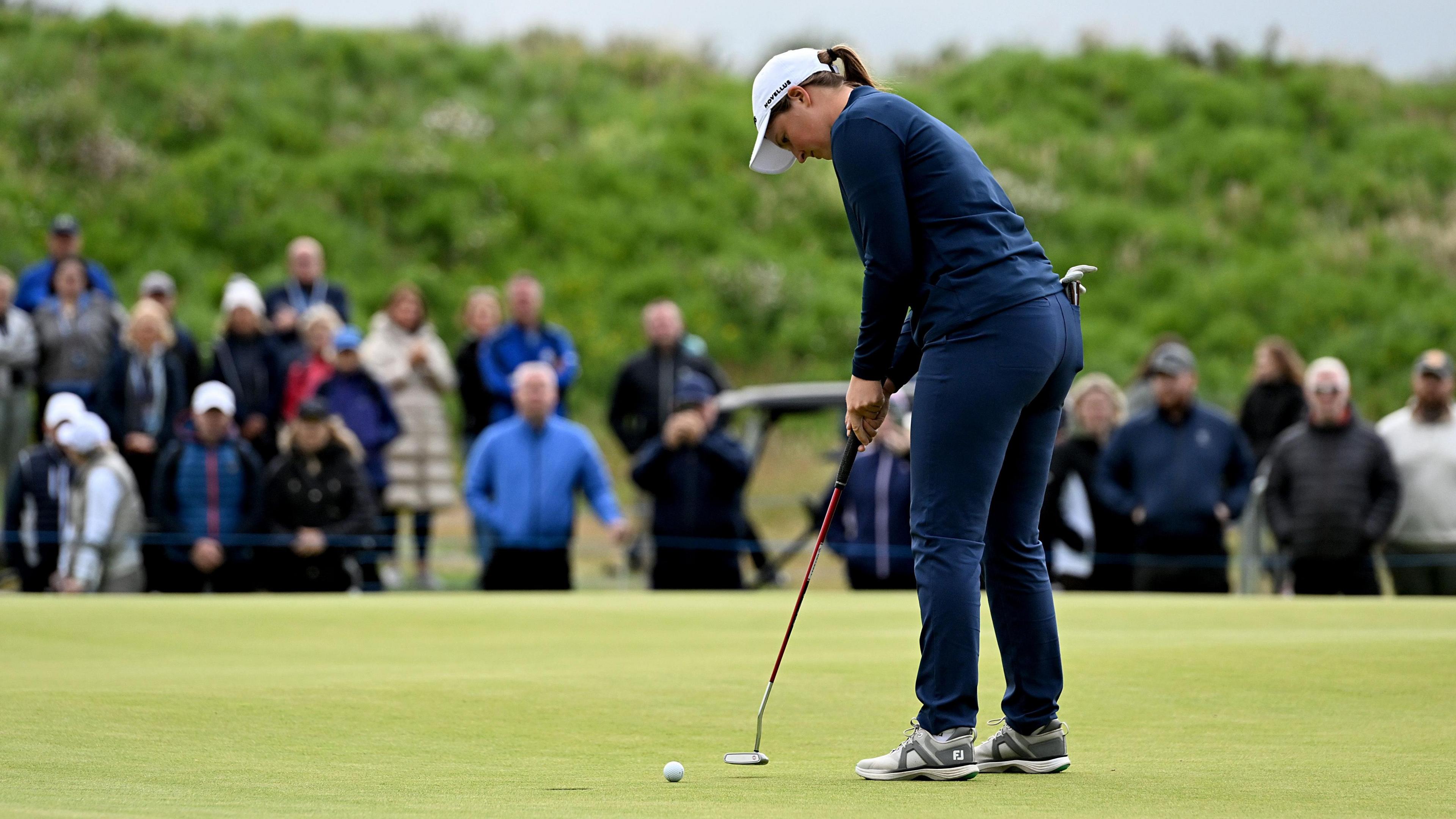 Lottie Woad puts connected nan 18th green