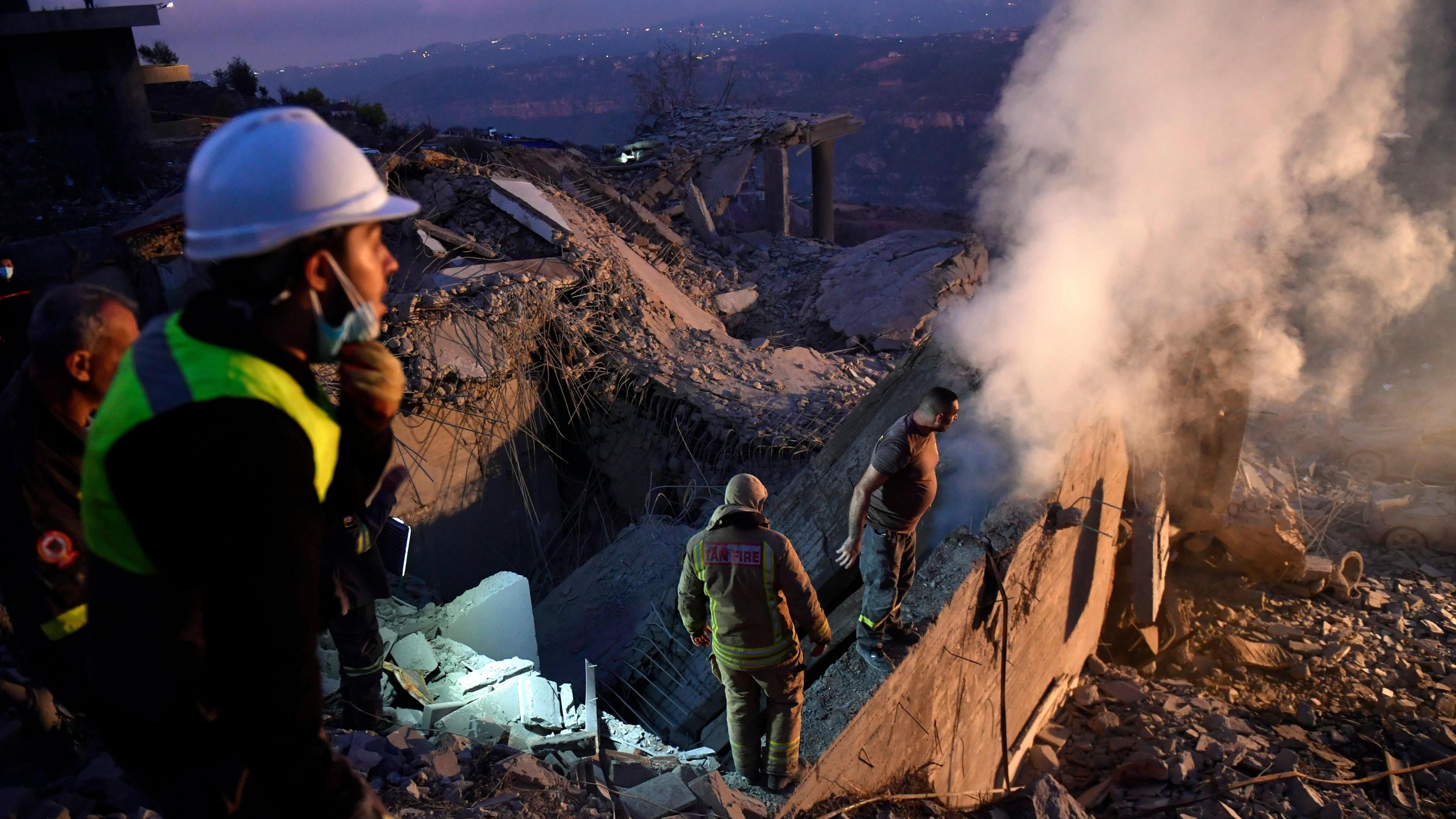 Lebanese first responders search for survivors amid the rubble of a home destroyed in an Israeli air strike, near Baalchmay, central Lebanon (12 November 2024)