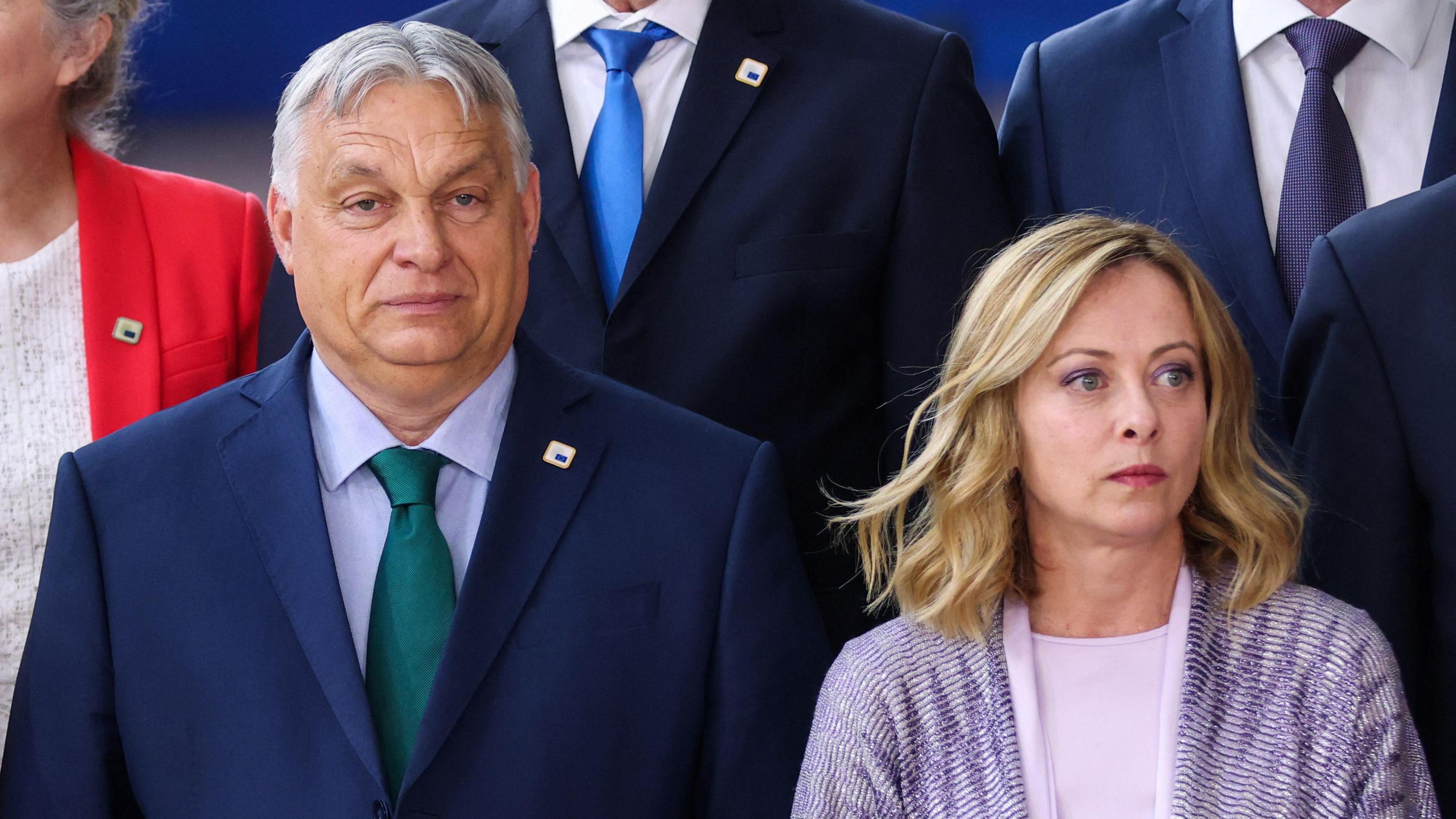 Hungary's Viktor Orban and Italy's Giorgia Meloni standing near each other