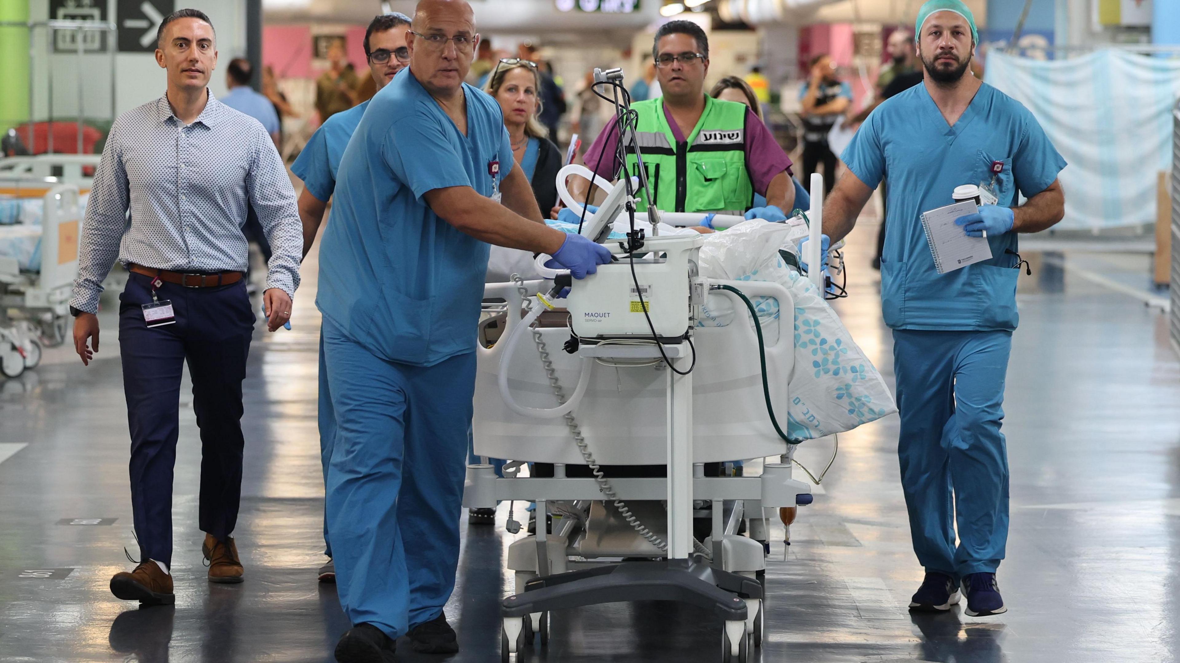 Medical teams transport patients to Rambam Hospital's underground emergency facility, in Haifa, northern Israel, 22 September 2024