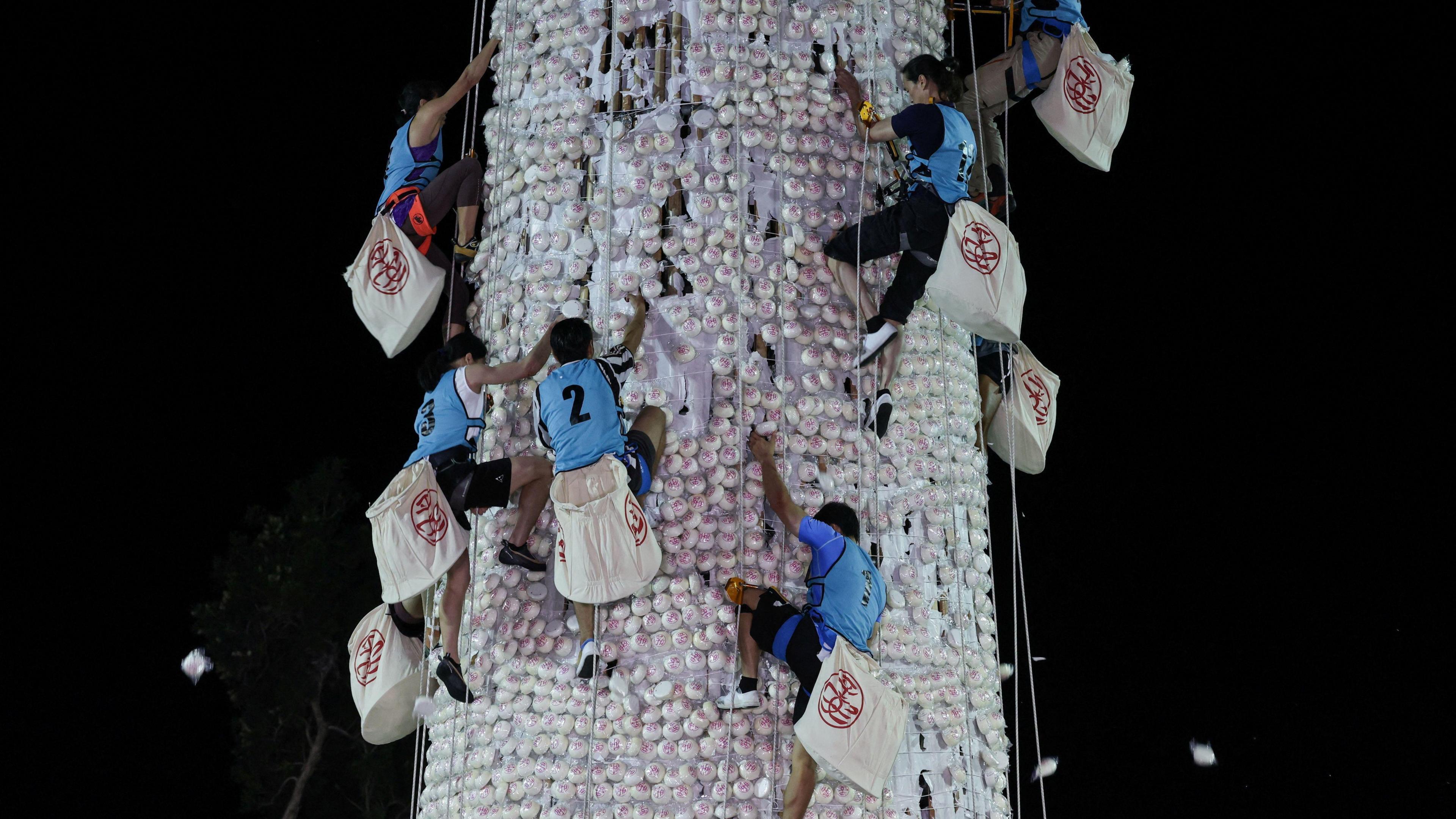 Participants compete to climb a 14-metre bun tower during the bun-snatching competition.