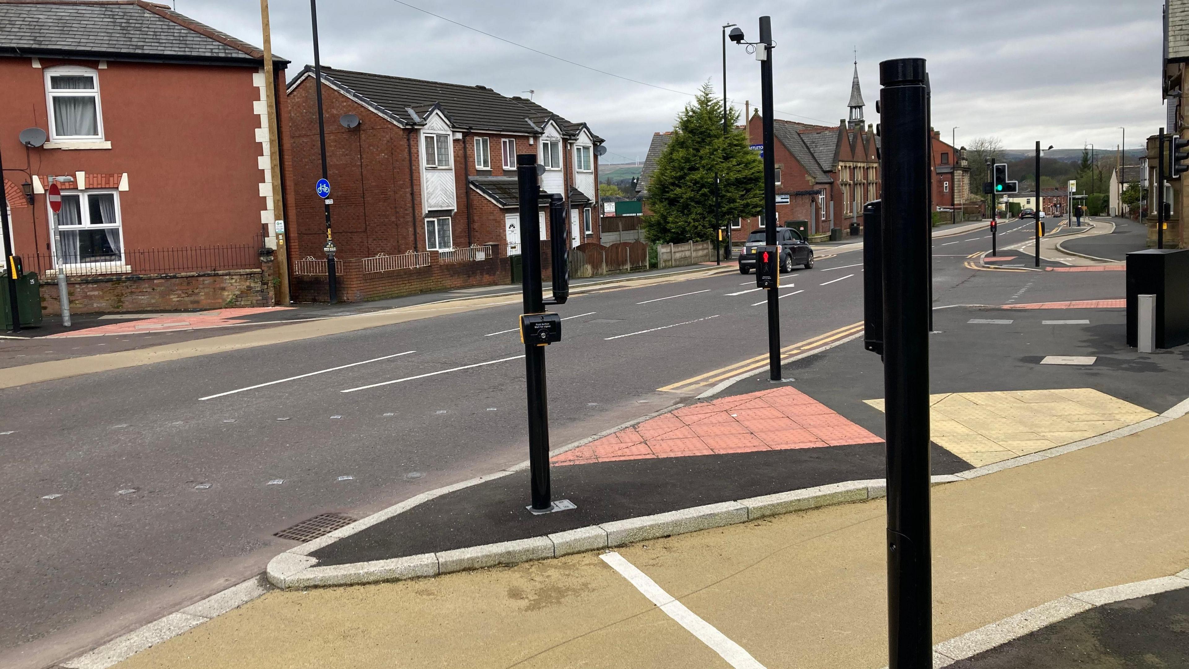 Roadside view of part of the Castleton cycle lane by a pedestrian crossing