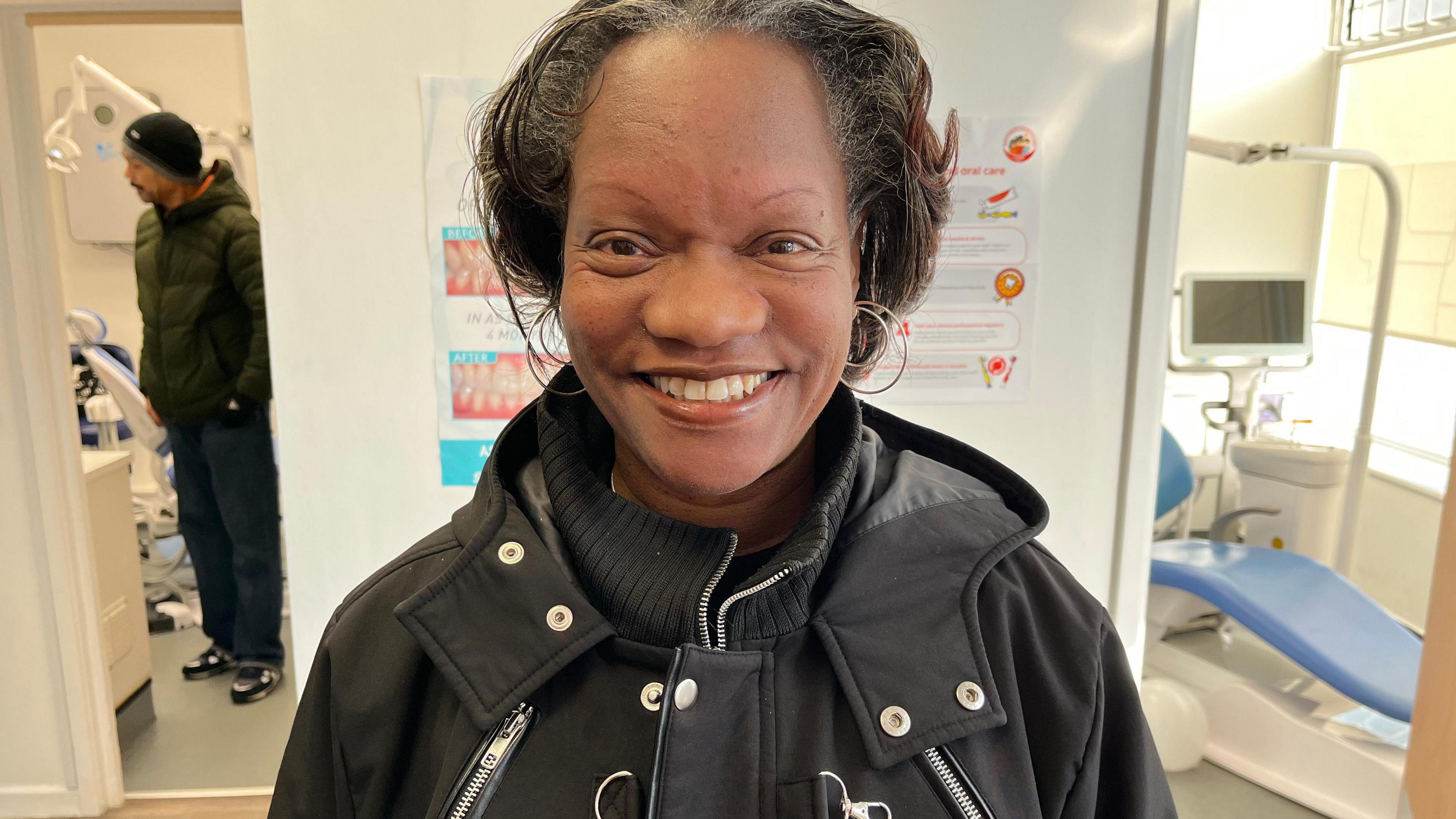 Carol Sherman, pictured inside the dental surgery smiling at the camera