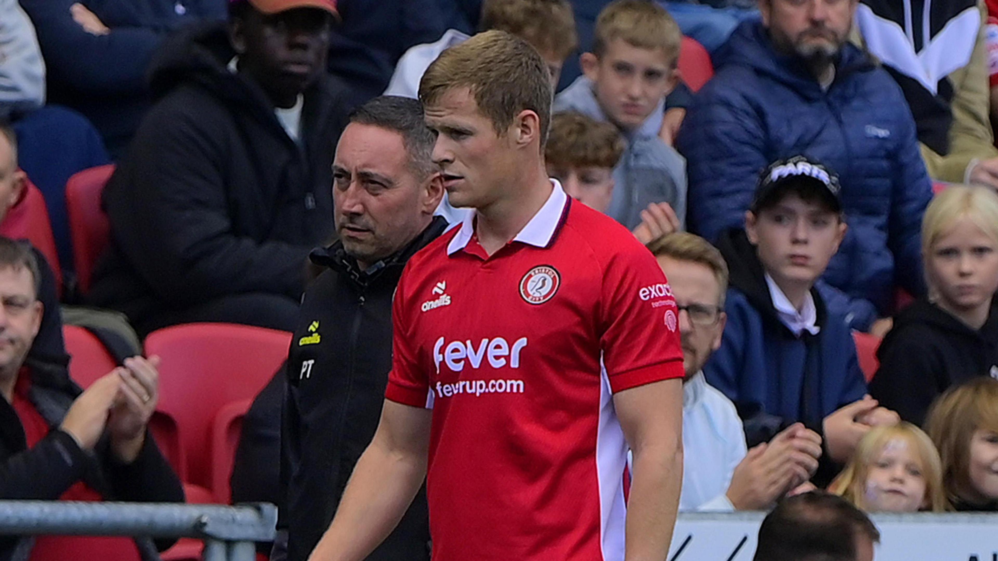 Rob Atkinson walking down the touchline after being substituted for Bristol City