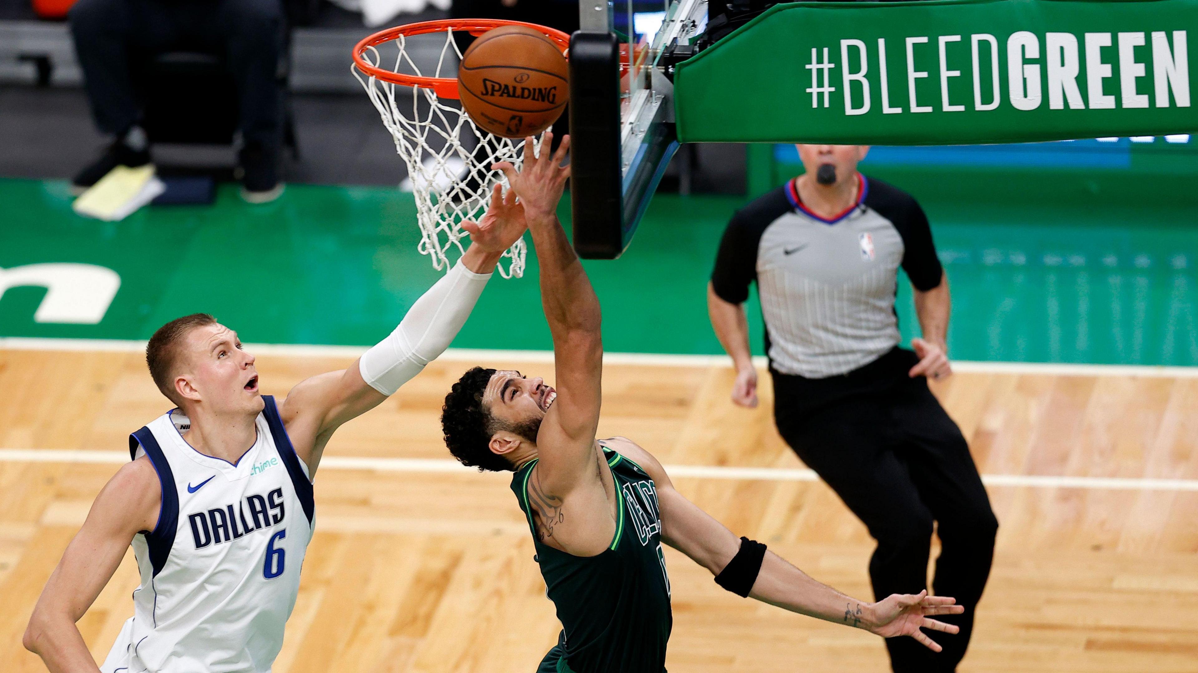 Kristaps Porzingis attempts to block a shot from Jayson Tatum