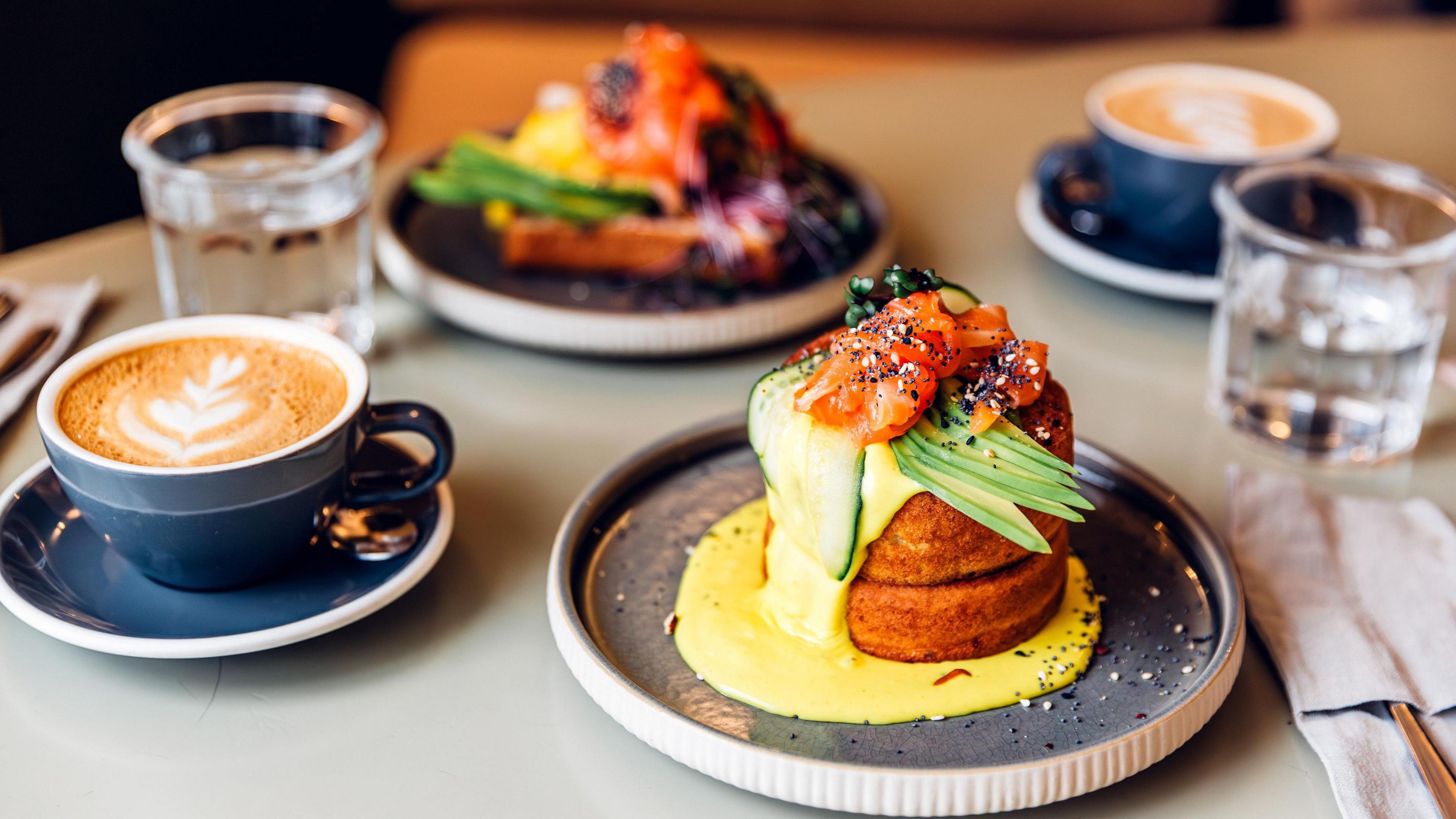 Fluffy pancakes with salmon and avocado served for breakfast at the restaurant.