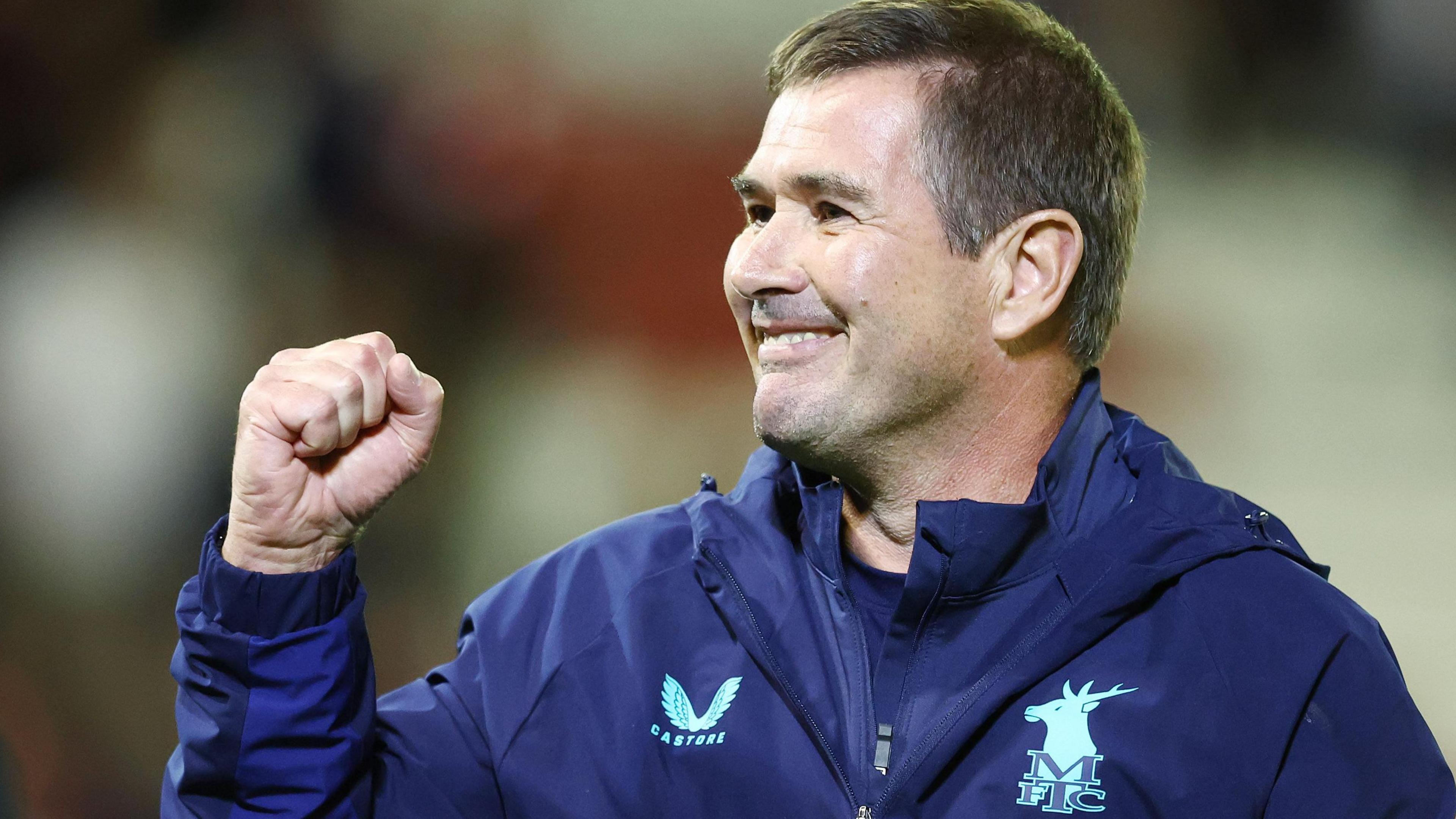 Mansfield Town boss Nigel Clough pumps his fist in the air